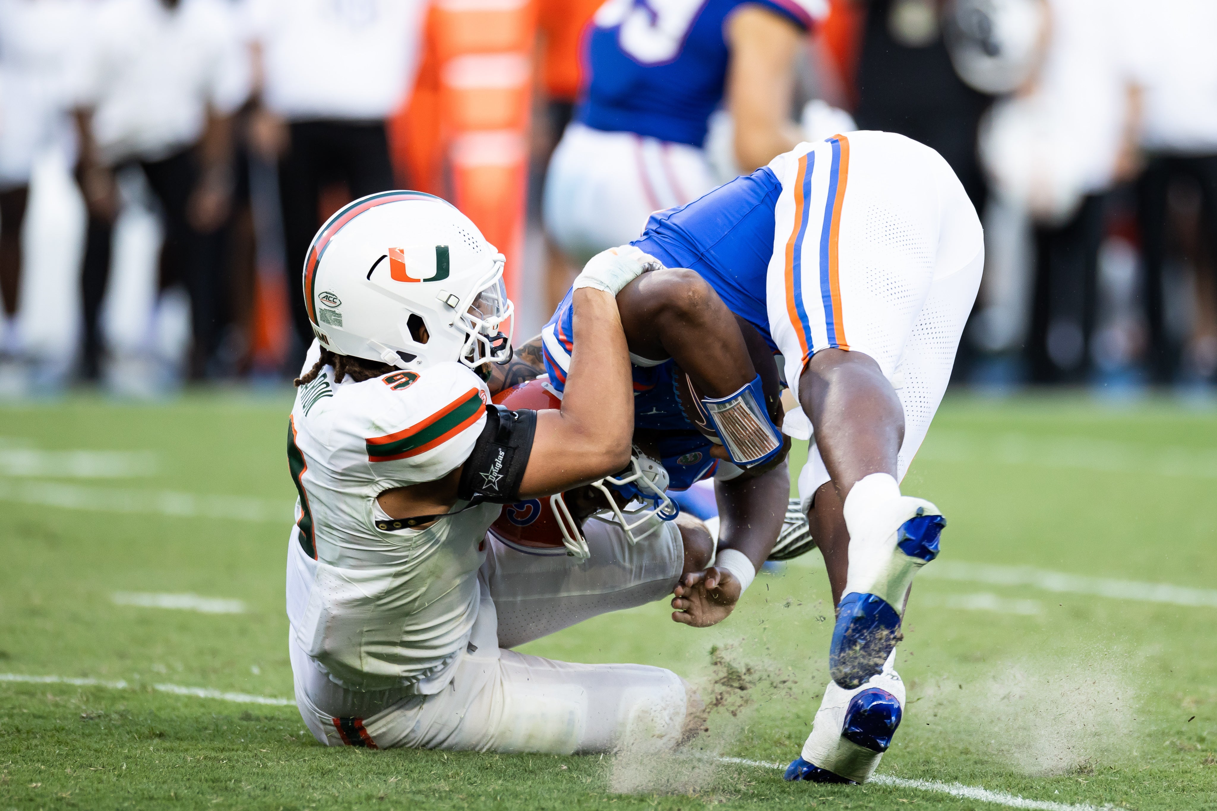 Aug 31, 2024; Gainesville, Florida, USA; Miami Hurricanes defensive lineman C.J. Clark (5) tackles Florida Gators quarterback DJ Lagway (2) during the second half at Ben Hill Griffin Stadium.