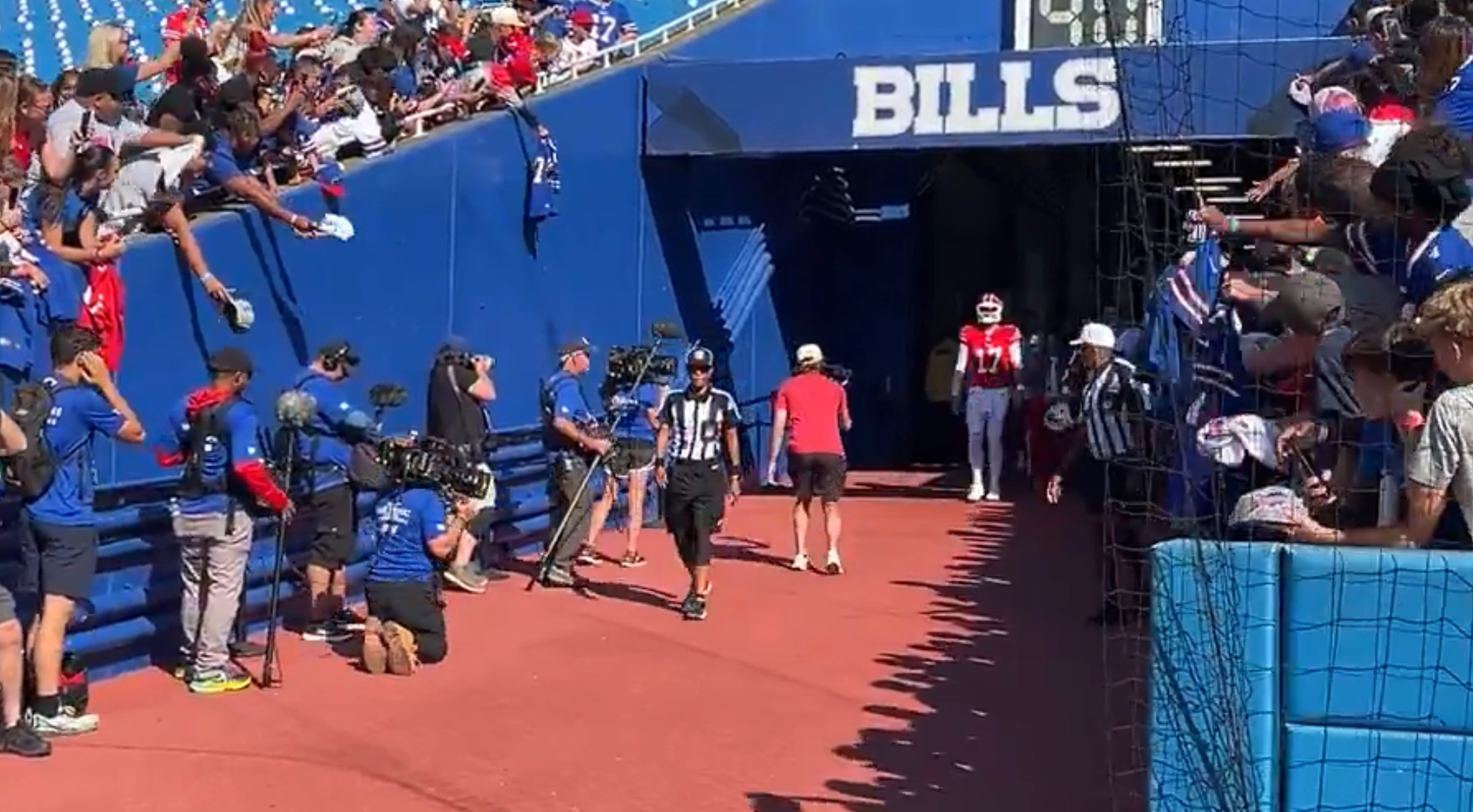 Buffalo Bills QB Josh Allen walks into Highmark Stadium for Red & Blue practice wearing a red helmet