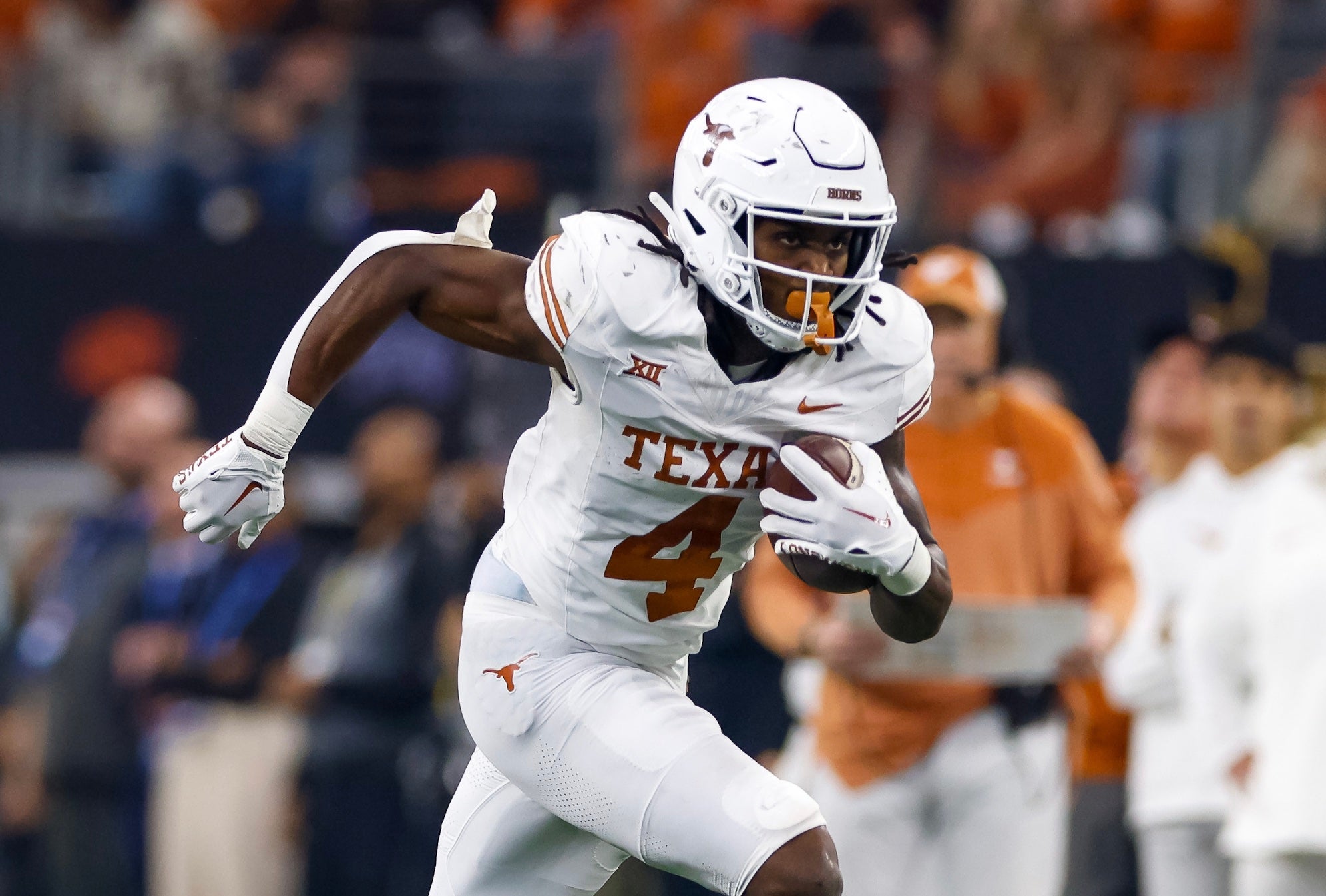 Texas Longhorns running back CJ Baxter (4) runs with the ball during the second quarter against the Oklahoma State Cowboys at AT&T Stadium.