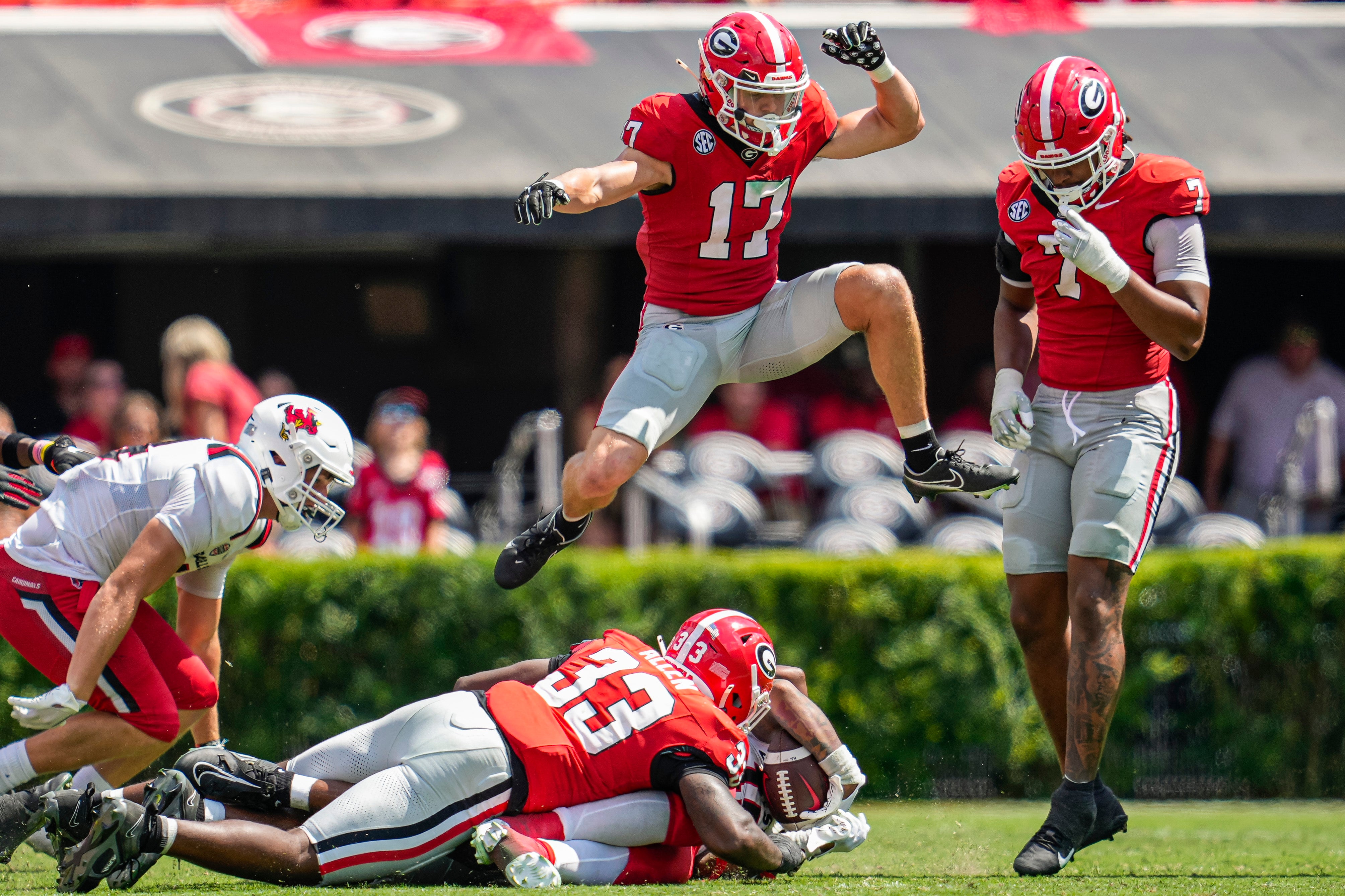 Georgia Bulldogs defensive back Dan Jackson (17) jumps over players after a play against the Ball State Cardinals during the second half at Sanford Stadium. Dale Zanine-Imagn Images