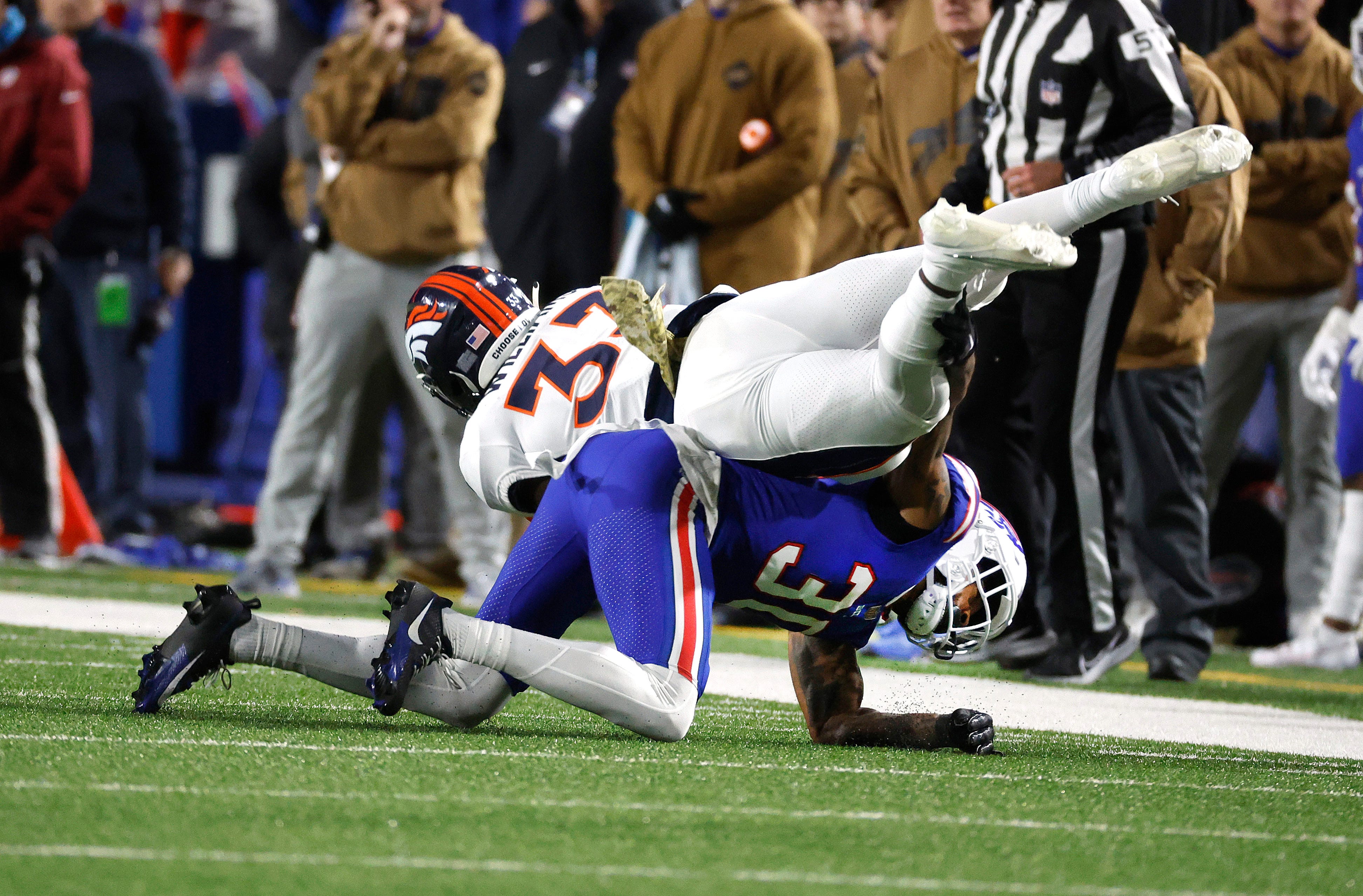 Buffalo Bills cornerback Dane Jackson (30) makes the tackle on Denver Broncos running back Javonte Williams (33).