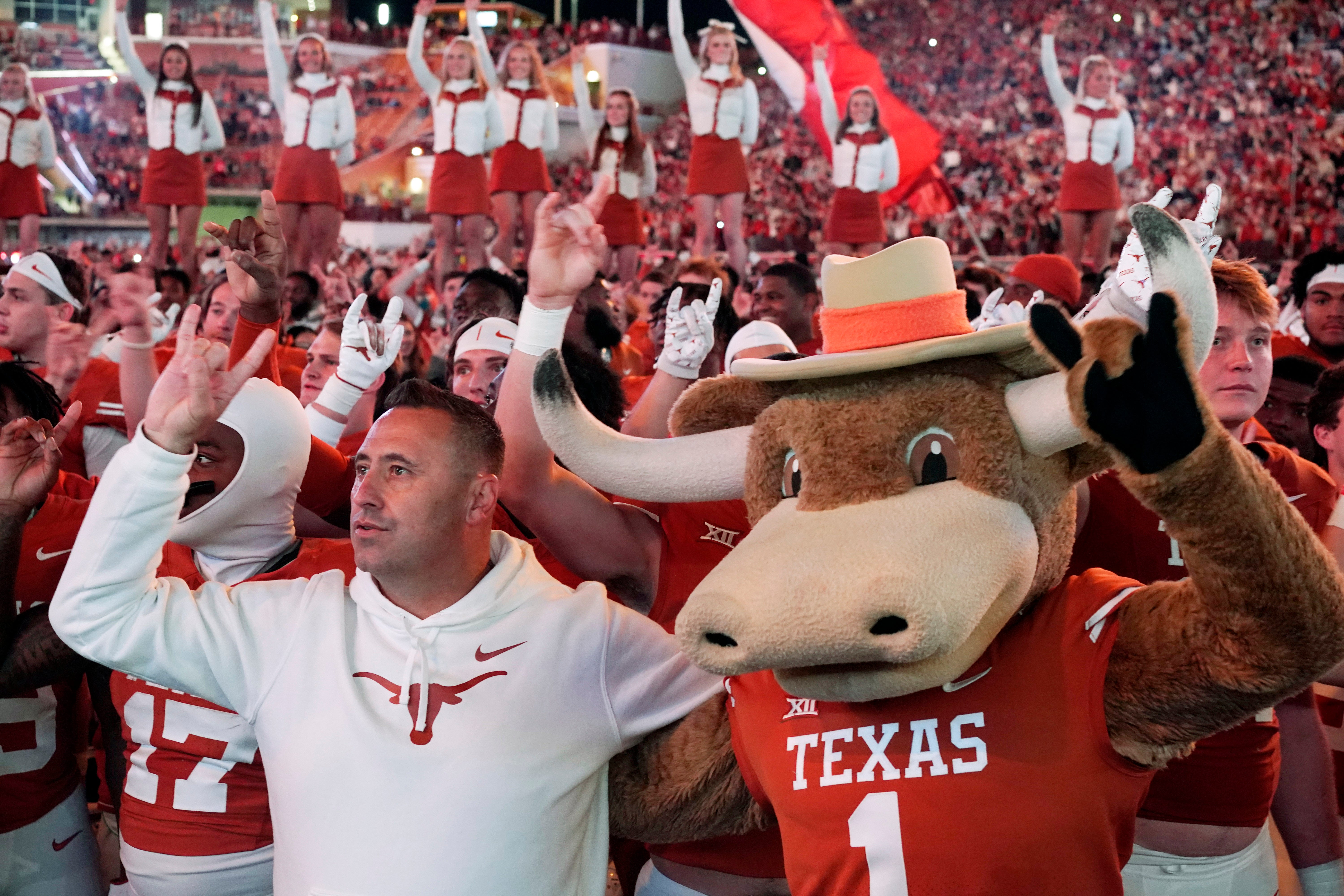 Nov 24, 2023; Austin, Texas, USA; Texas Longhorns head coach Steve Sarkisian along mascot Hook Em and players acknowledge fans after a victory over the Texas Tech Red Raiders at Darrell K Royal-Texas Memorial Stadium.
