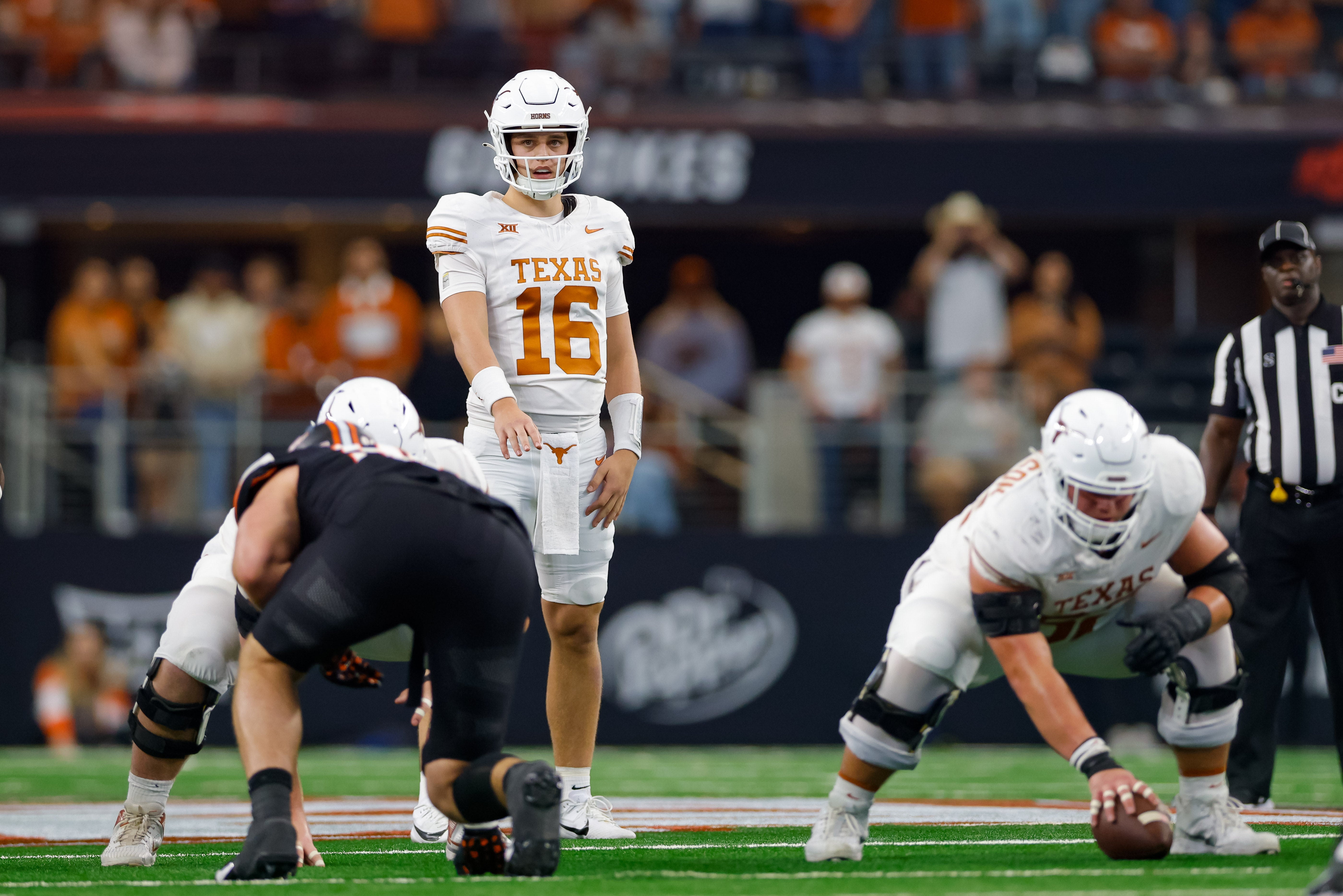 Dec 2, 2023; Arlington, TX, USA; Texas Longhorns quarterback Arch Manning (16) lines up behind center against the Oklahoma State Cowboys during the fourth quarter at AT&T Stadium.