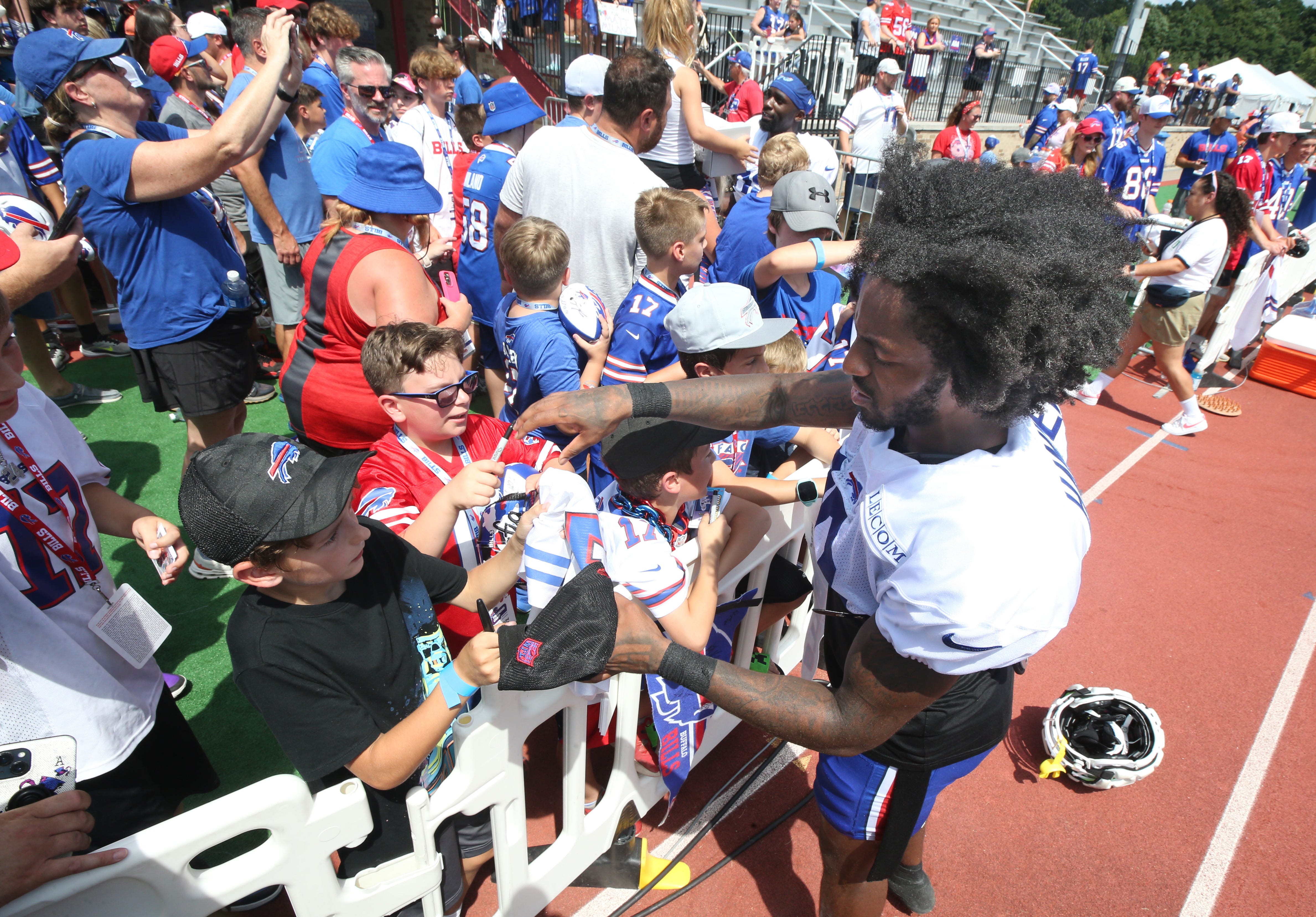 Bills wide receiver K.J. Hamler signs autographs for fans after day six of camp.