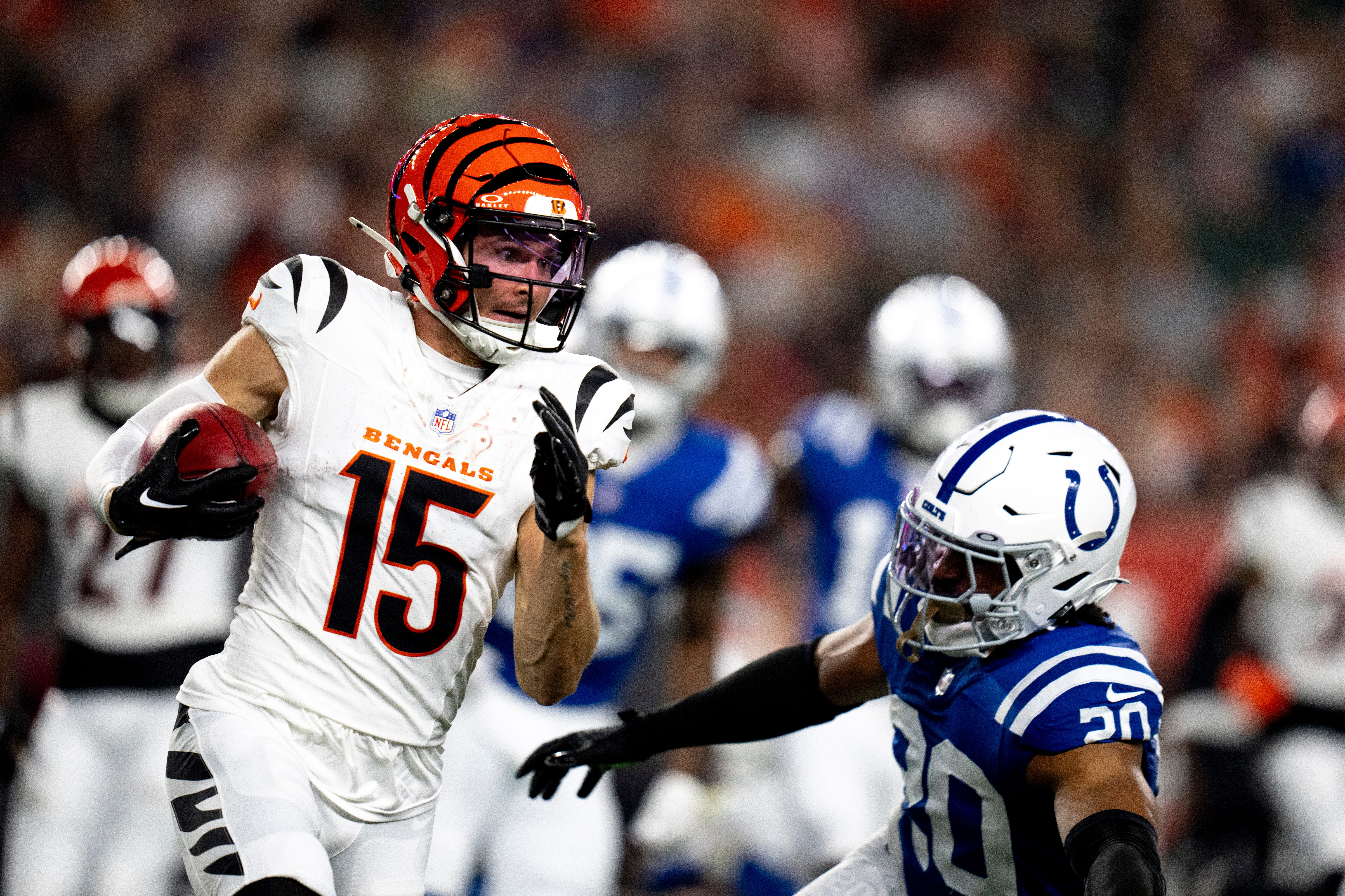 Cincinnati Bengals wide receiver Charlie Jones (15) returns a kickoff Indianapolis Colts safety Nick Cross (20) goes to tackle him in the first quarter of the NFL preseason game at Paycor Stadium in Cincinnati on Thursday, Aug. 22, 2024.