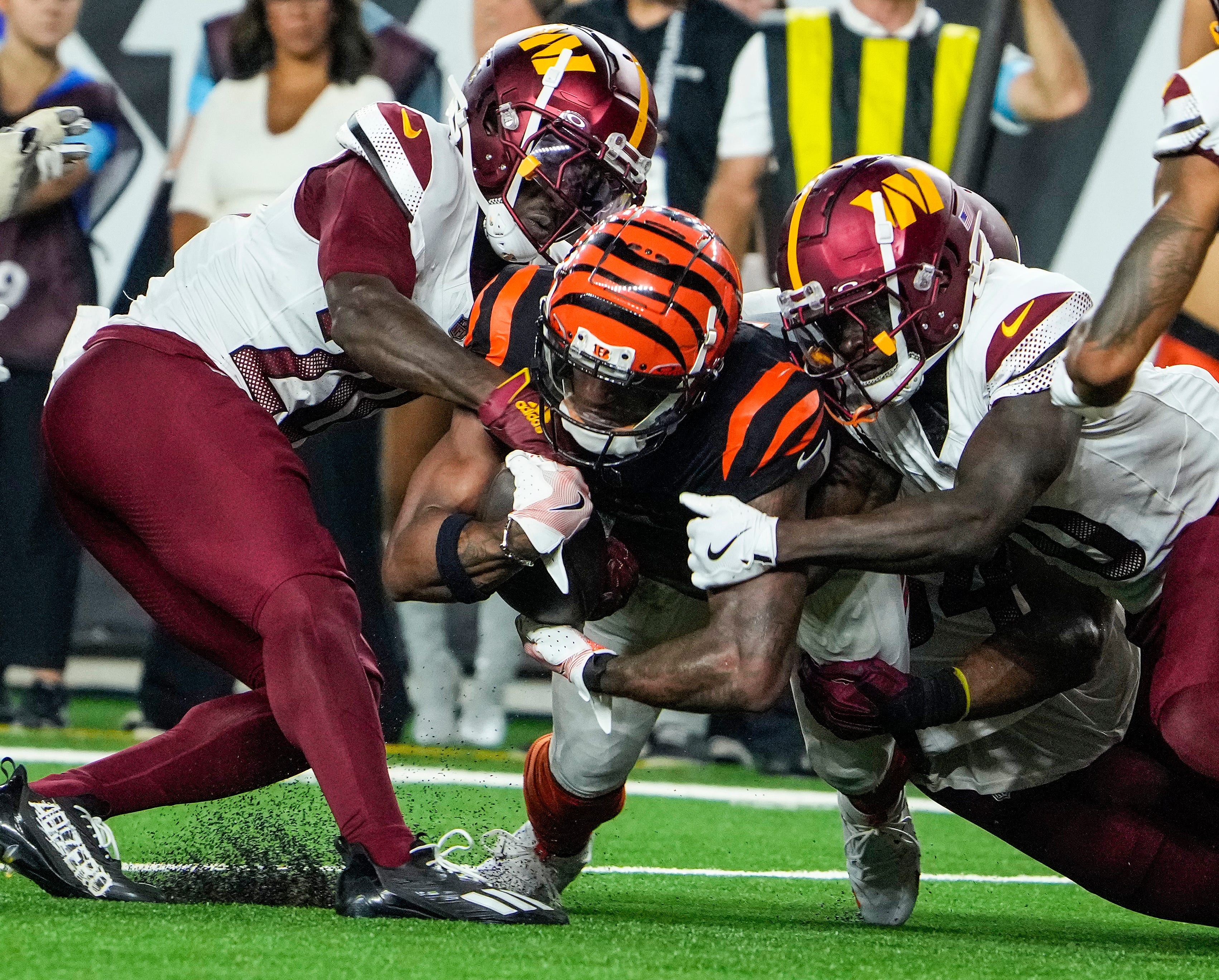 Cincinnati Bengals wide receiver Ja'Marr Chase (1) is taken down by the Washington Commanders defense in the 3rd quarter Monday, September 23, 2024 at Paycor Stadium. The Bengals lost 38-33.