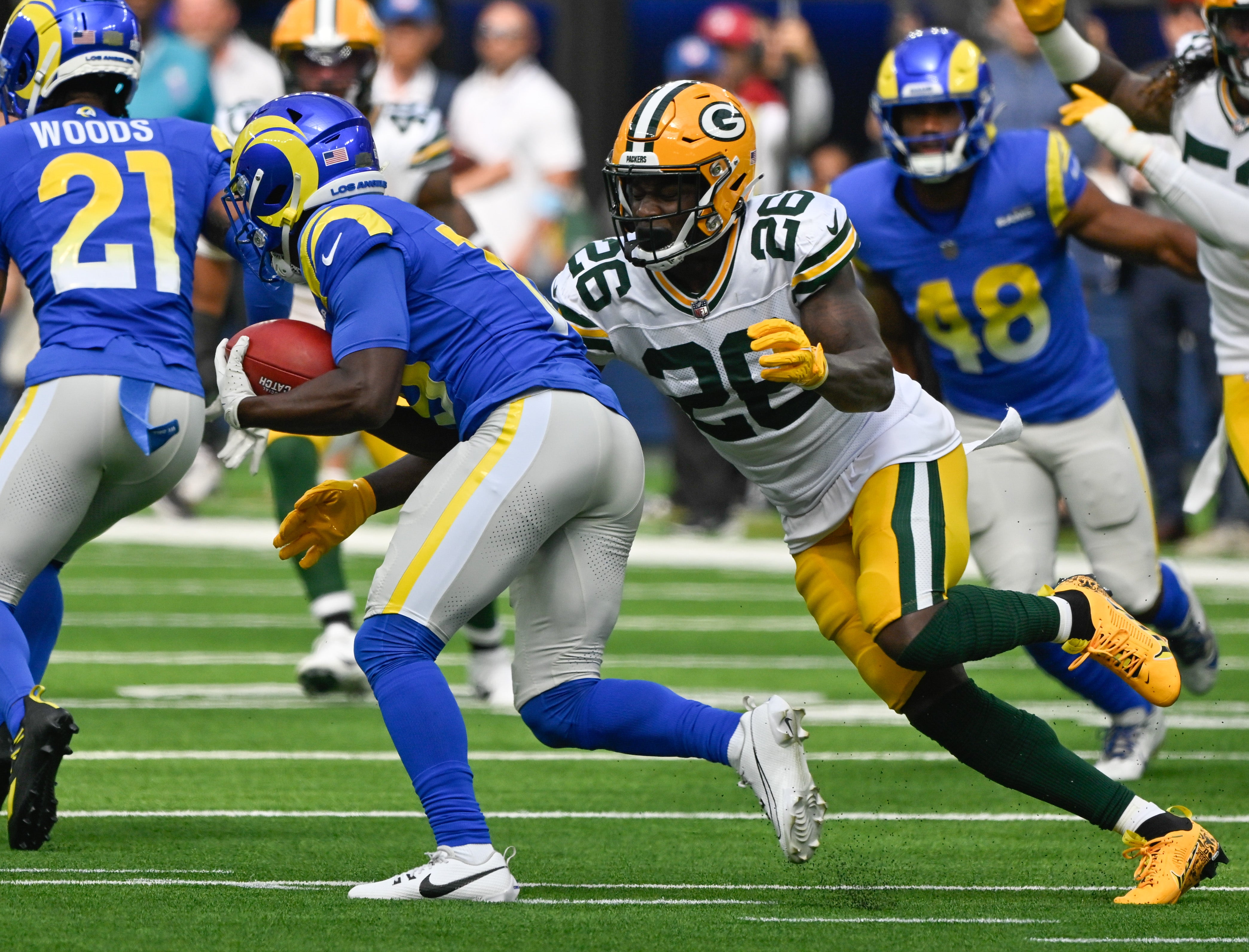 Green Bay Packers cornerback Corey Ballentine (26) tackles Los Angeles Rams wide receiver Xavier Smith (19) during the first quarter at SoFi Stadium.