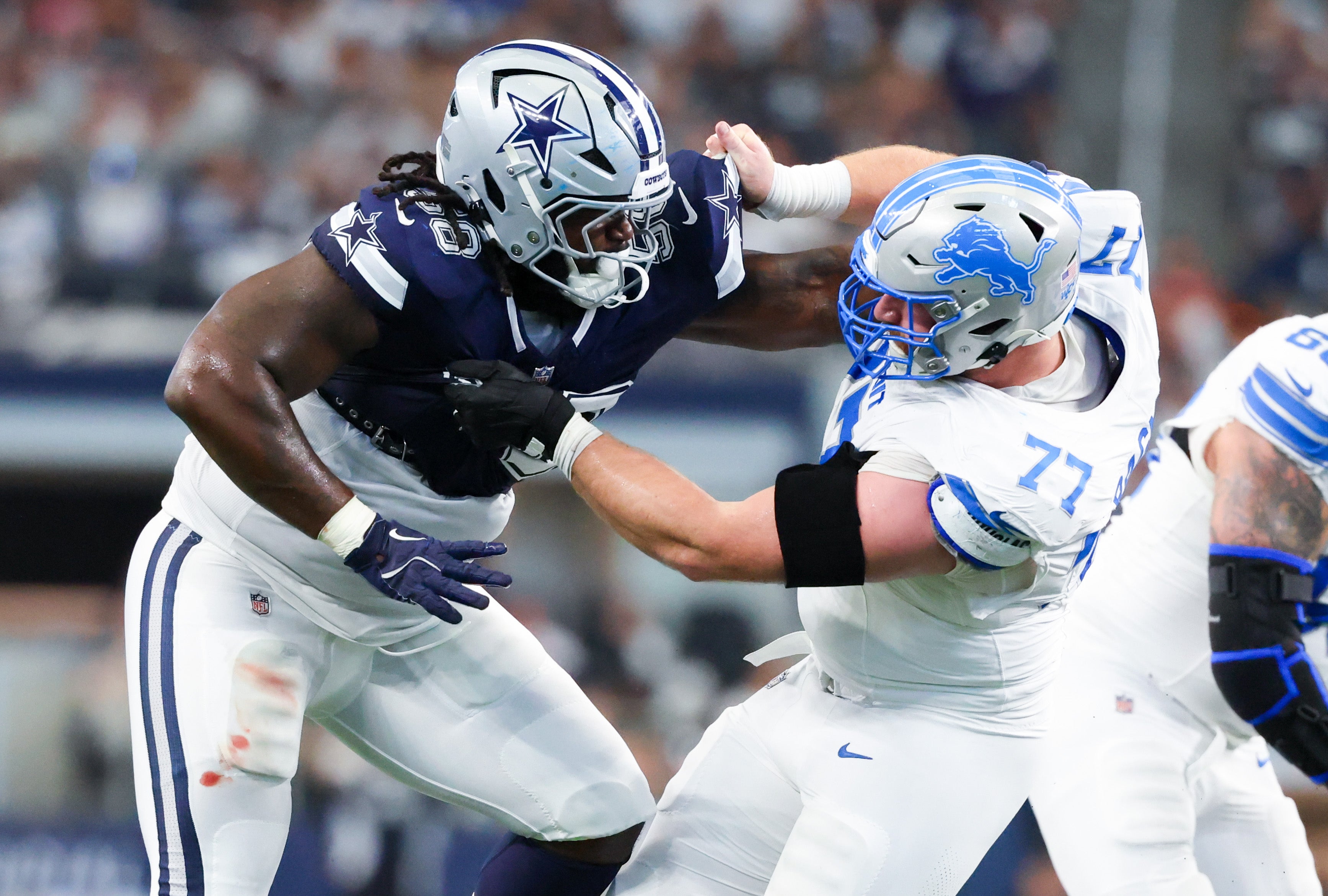 Dallas Cowboys defensive tackle Mazi Smith (58) and Detroit Lions center Frank Ragnow (77) battle during the second quarter at AT&T Stadium.