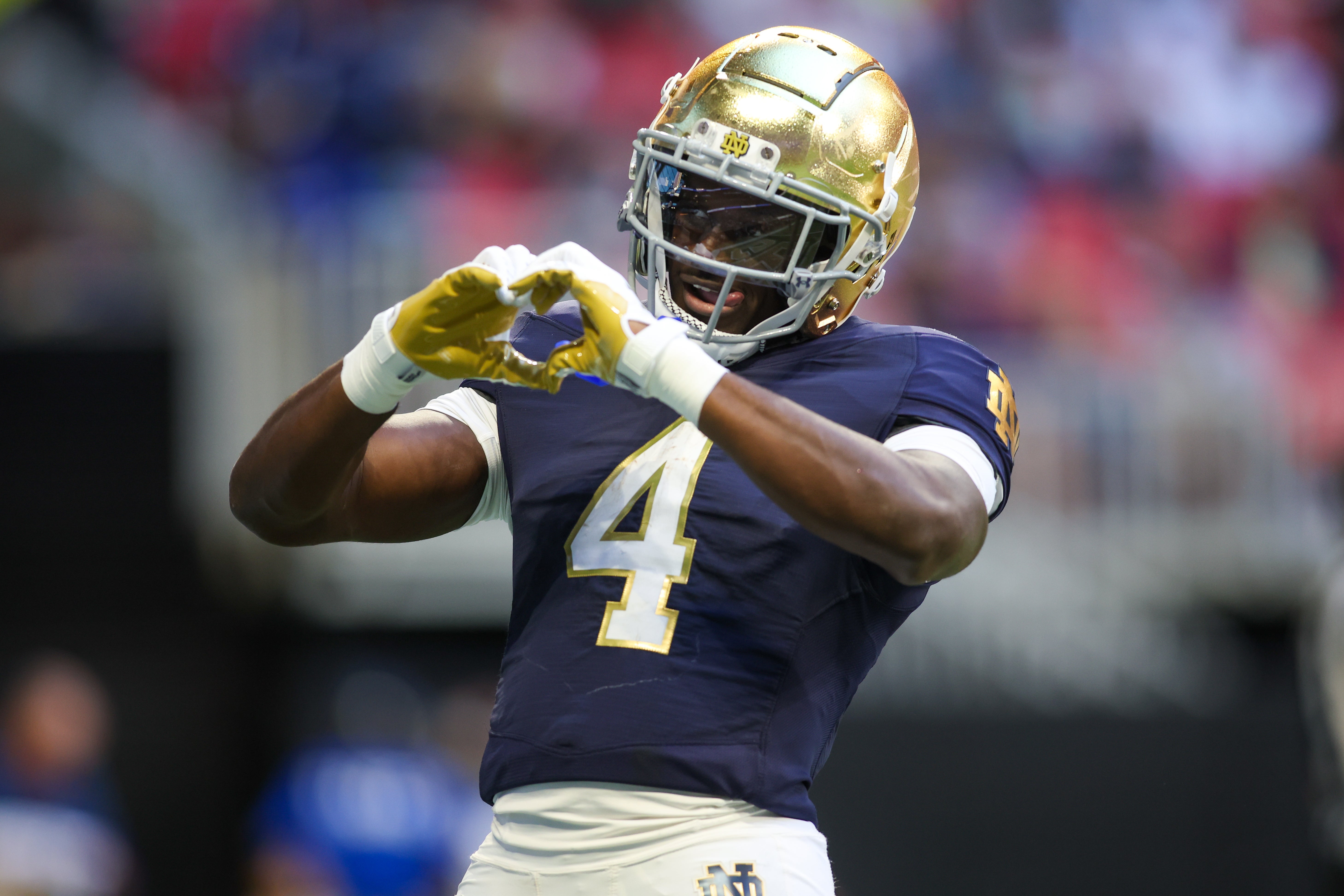 Oct 19, 2024; Atlanta, Georgia, USA; Notre Dame Fighting Irish running back Jeremiyah Love (4) celebrates after a touchdown against the Georgia Tech Yellow Jackets in the third quarter at Mercedes-Benz Stadium. Mandatory Credit: Brett Davis-Imagn Images