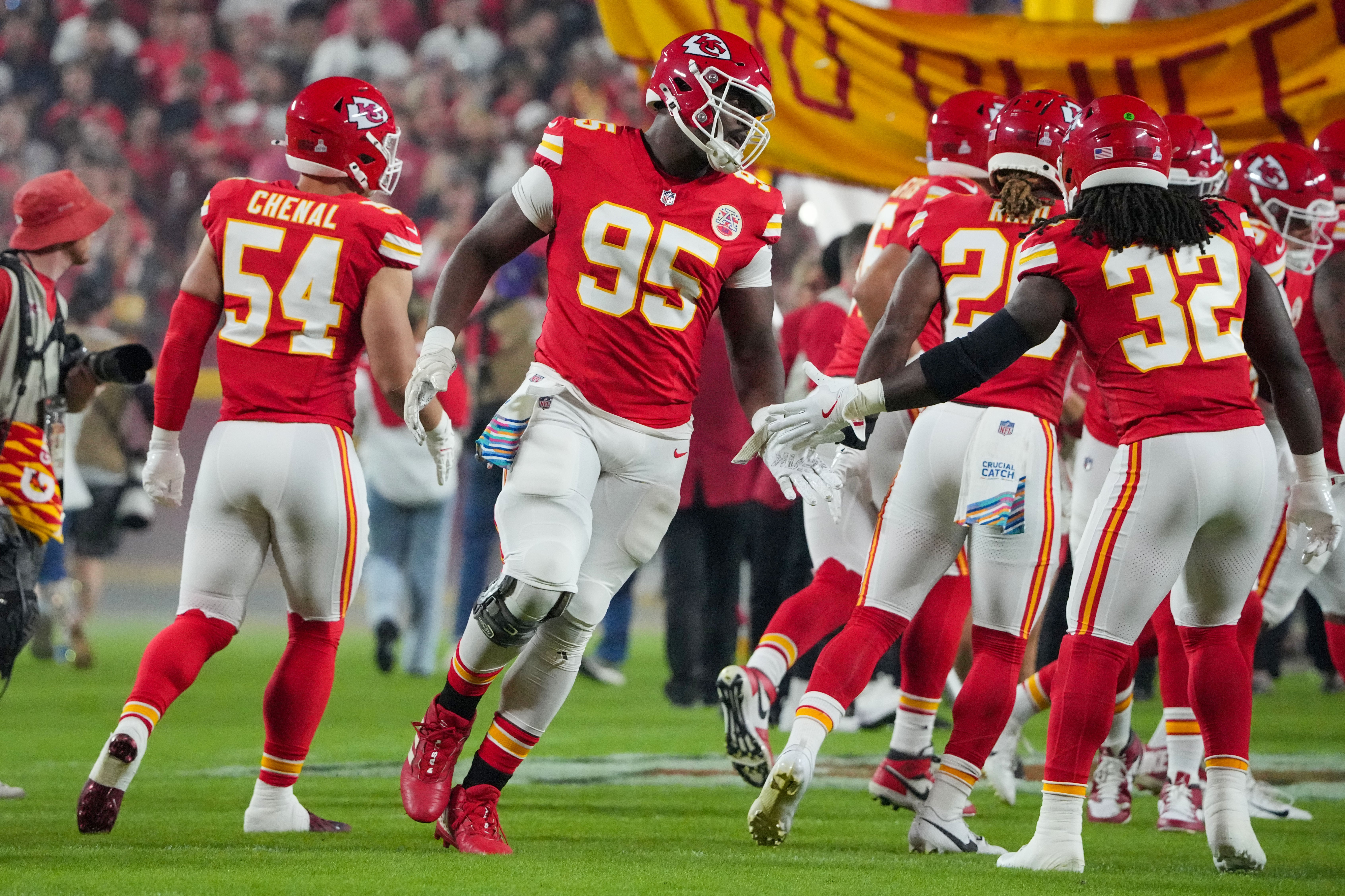 Kansas City Chiefs defensive tackle Chris Jones (95) celebrates with linebacker Nick Bolton (32) during player introductions prior to a game