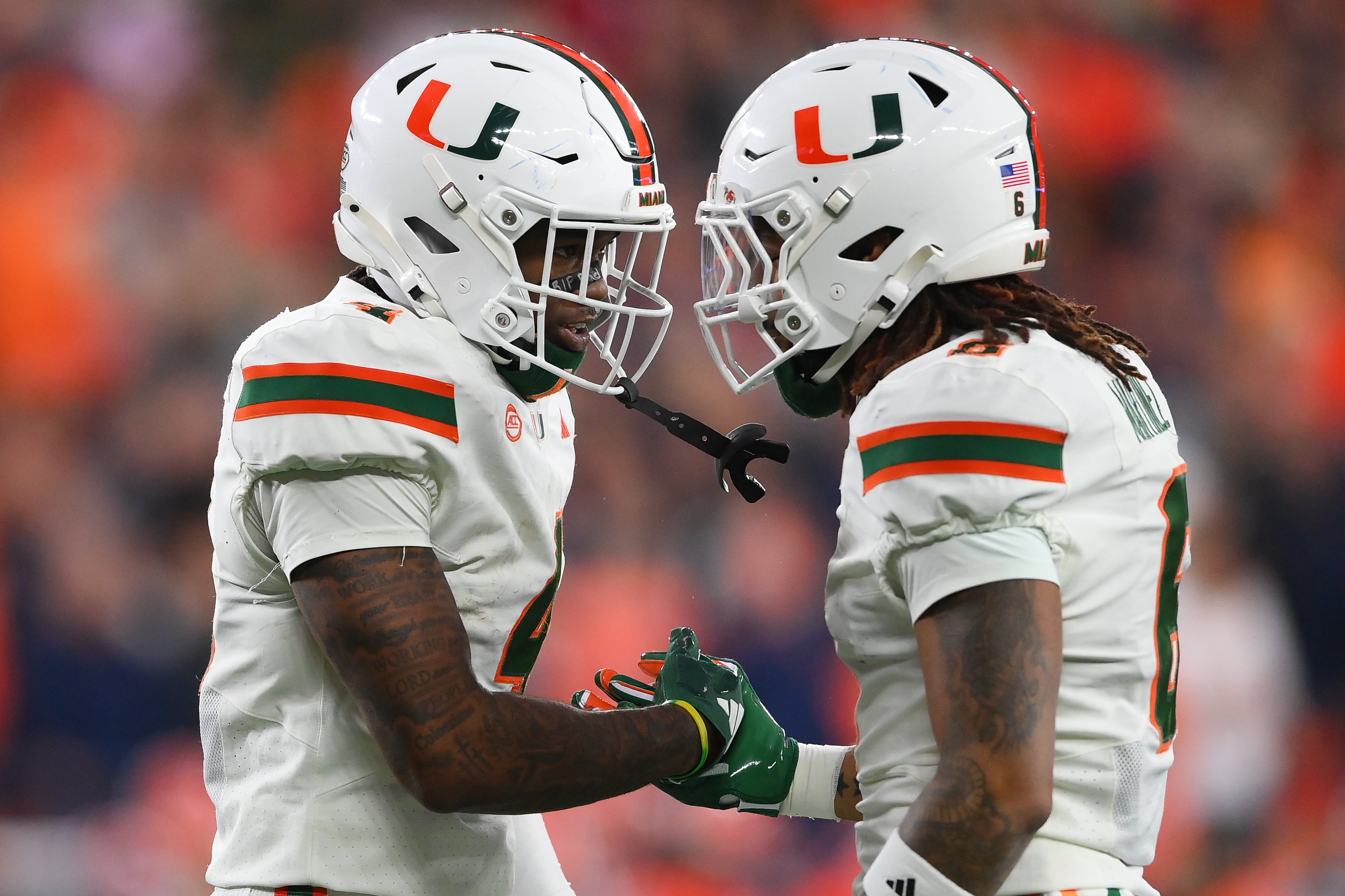 Nov 30, 2024; Syracuse, New York, USA; Miami Hurricanes running back Mark Fletcher Jr. (left) celebrates with running back Damien Martinez (right) after scoring a touchdown against the Syracuse Orange during the first half at the JMA Wireless Dome.