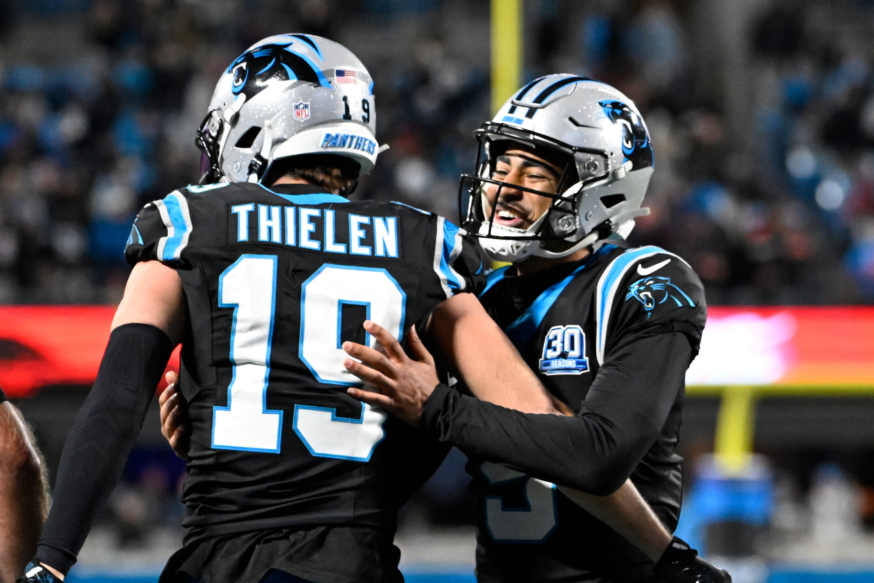 Dec 1, 2024; Charlotte, North Carolina, USA; Carolina Panthers wide receiver Adam Thielen (19) celebrates with quarterback Bryce Young (9) after scoring a touchdown with 30 seconds left in the fourth quarter at Bank of America Stadium.
