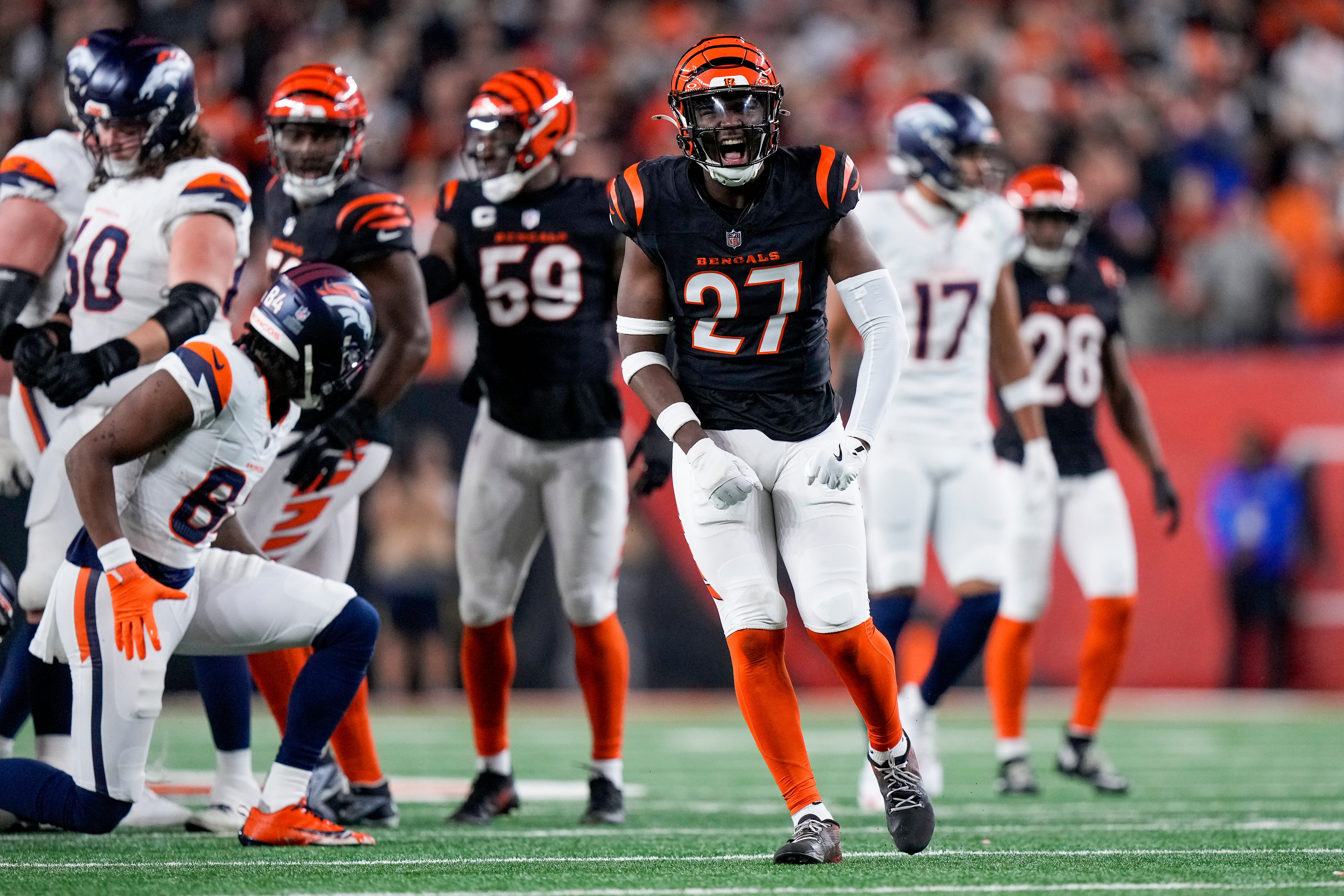 Cincinnati Bengals safety Jordan Battle (27) celebrates a stop in the fourth quarter of the NFL Week 17 game between the Cincinnati Bengals and the Denver Broncos at Paycor Stadium in downtown Cincinnati on Saturday, Dec. 28, 2024. The Bengals took a 30-24 win in overtime to remain in the post season chase.