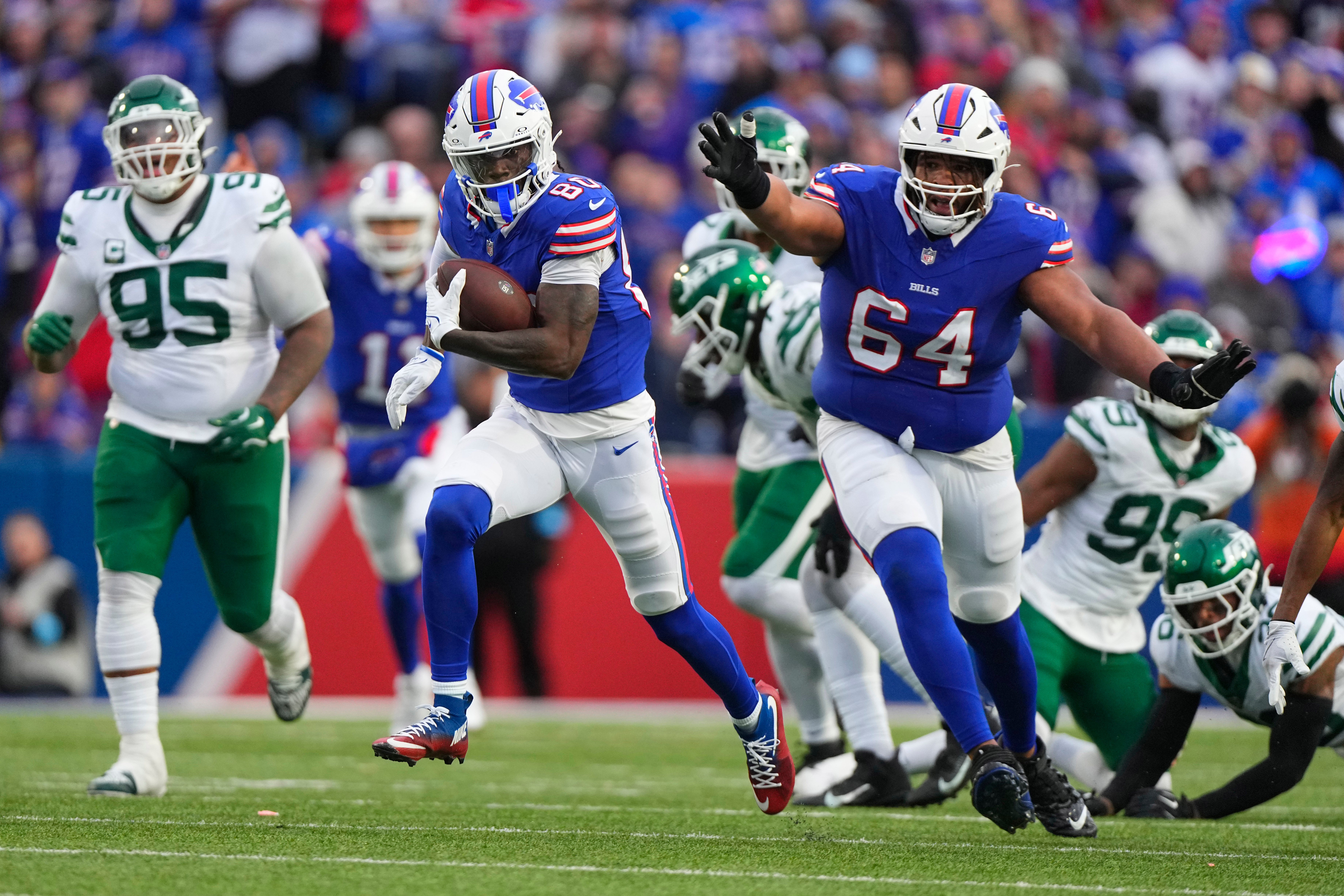 Dec 29, 2024; Orchard Park, New York, USA; Buffalo Bills wide receiver Tyrell Shavers (80) runs with the ball after making a catch and scores a touchdown against the New York Jets during the second half at Highmark Stadium.