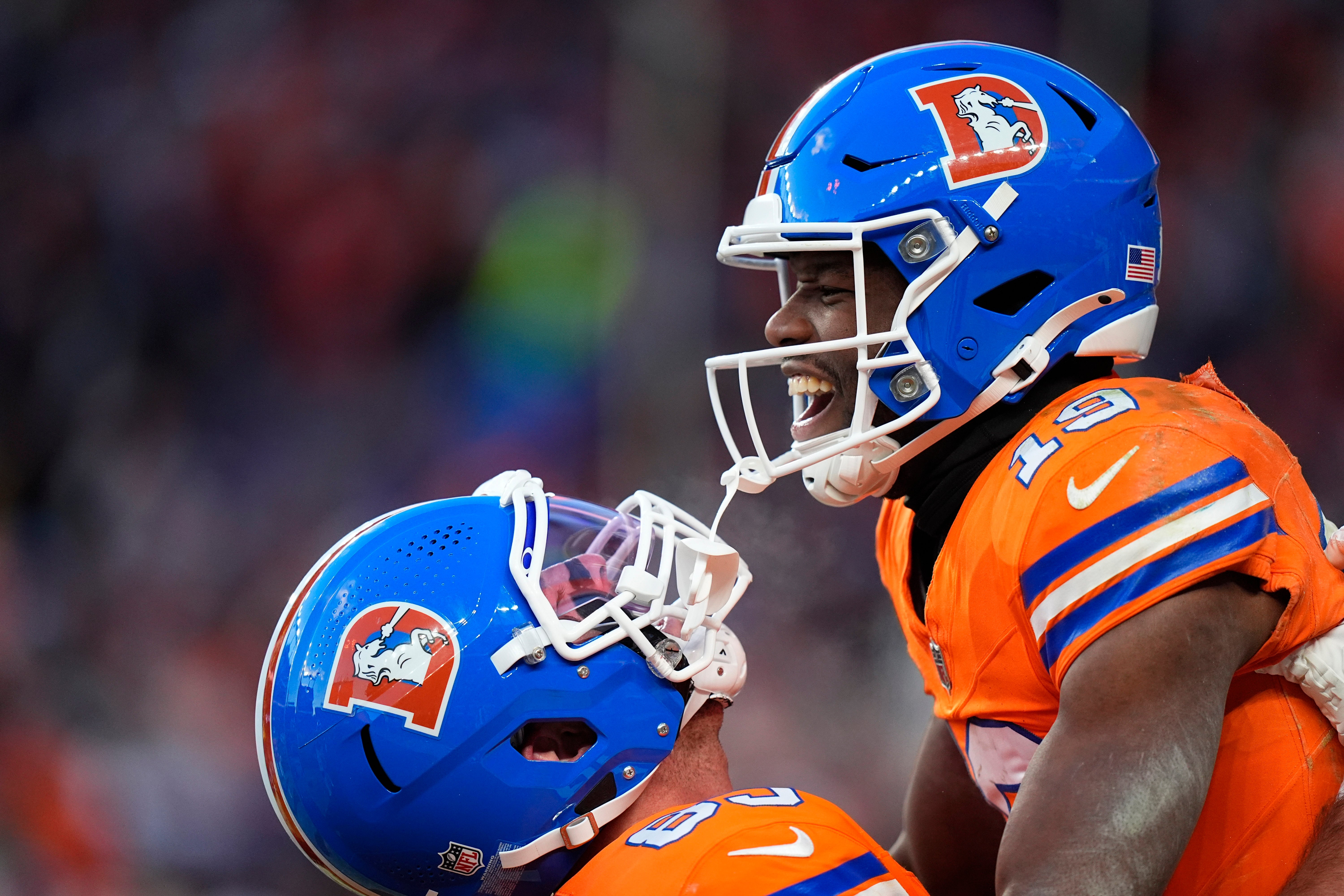 Jan 5, 2025; Denver, Colorado, USA; Denver Broncos wide receiver Marvin Mims Jr. (19) celebrates his touchdown withtight end Lucas Krull (85) in the second half against the Kansas City Chiefs at Empower Field at Mile High.