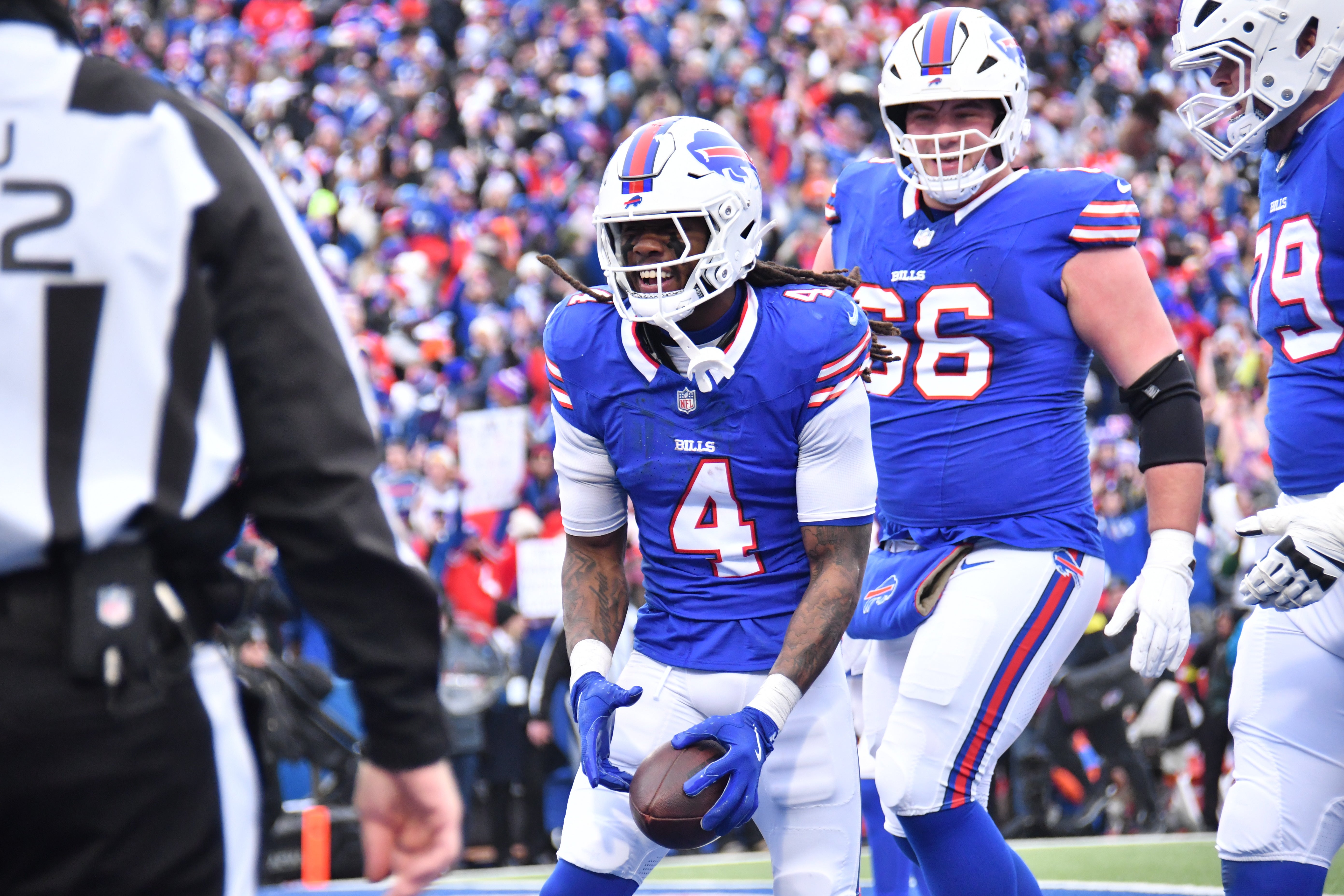 Buffalo Bills RB James Cook celebrates in the endzone after scoring a touchdown for the Buffalo Bills