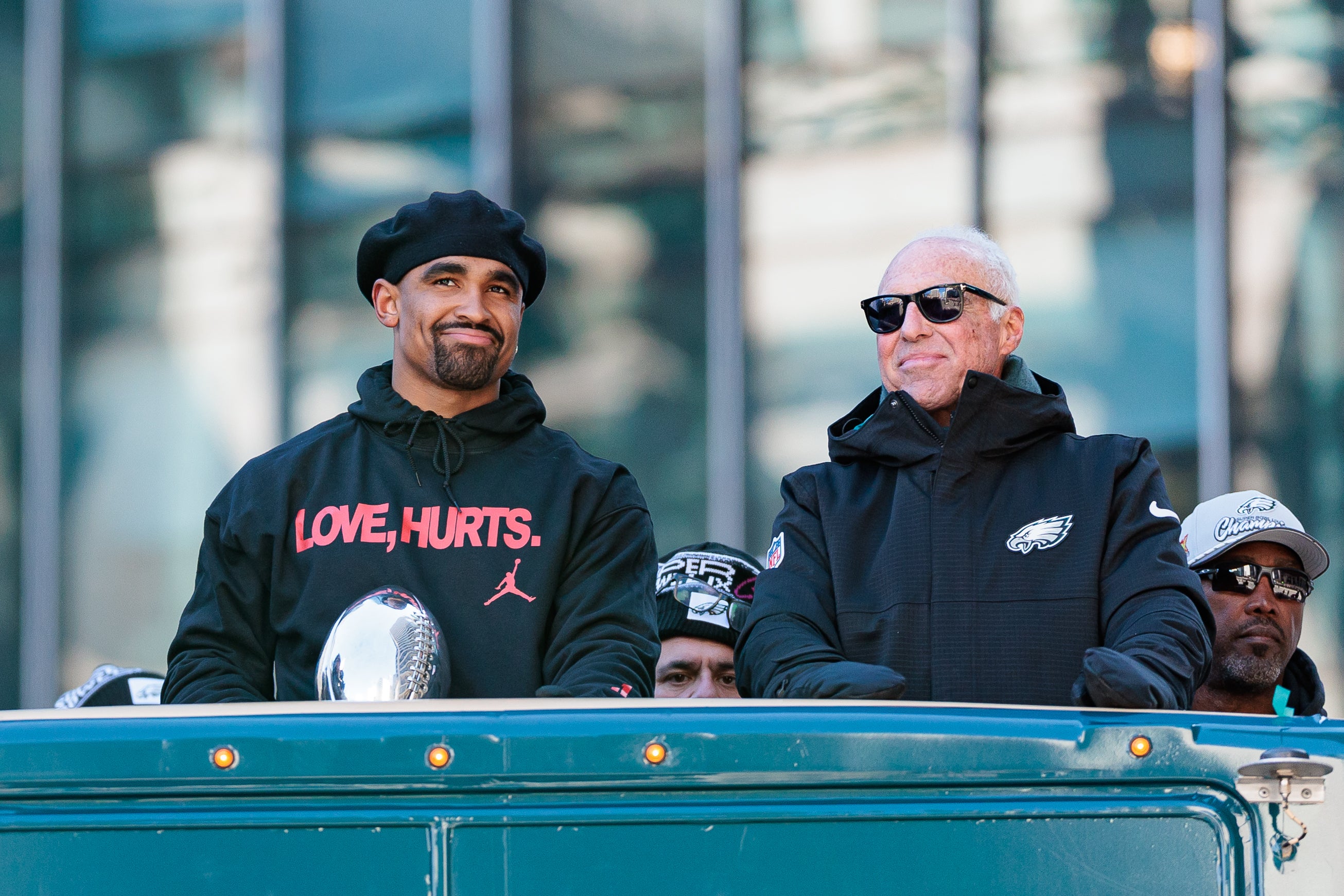 Philadelphia Eagles quarterback Jalen Hurts (1) speaks to team owner Jeffrey Lurie during the Super Bowl LIX championship parade and rally. Caean Couto-Imagn Images
