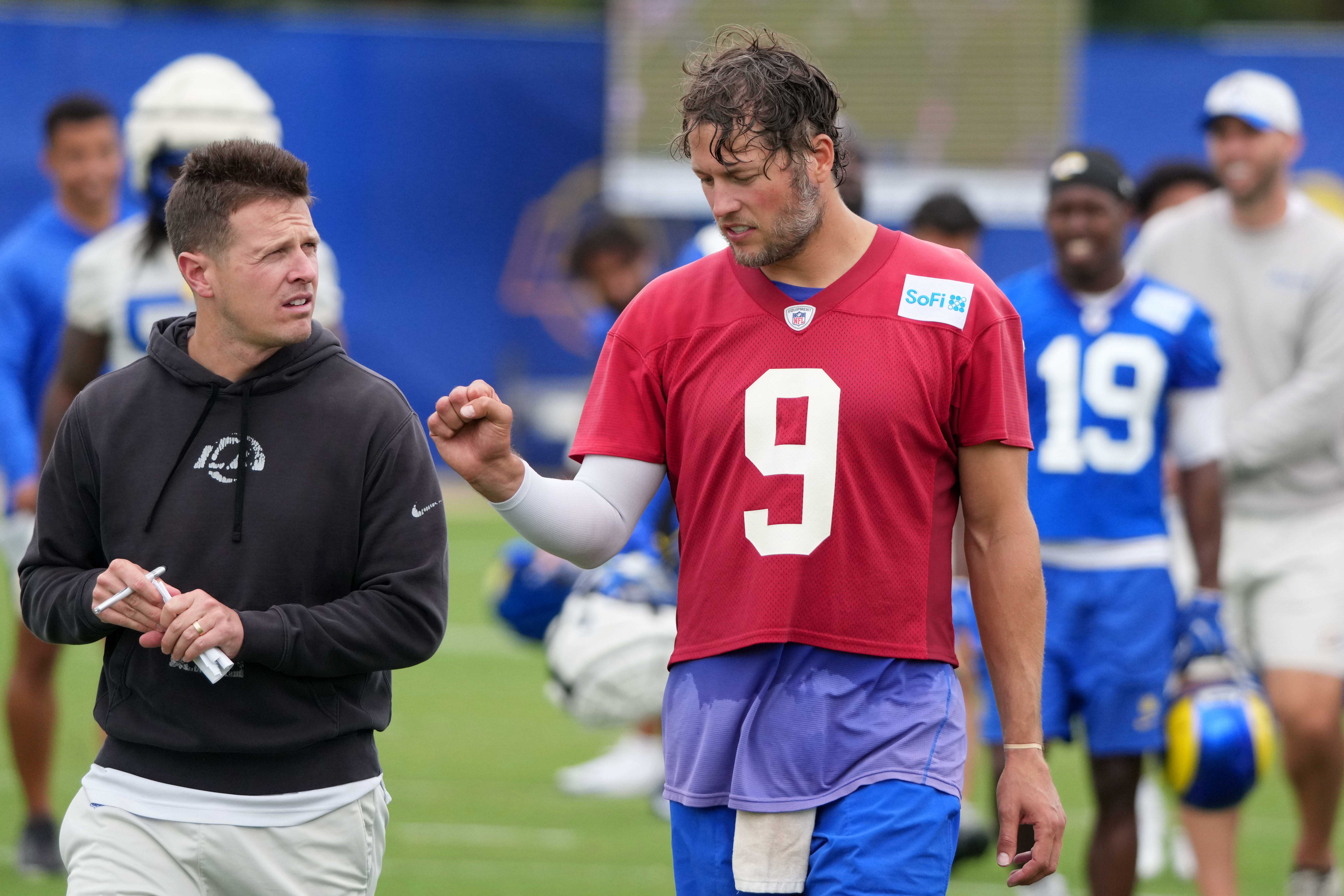 May 28, 2025; Woodland Hills, CA, USA; Los Angeles Rams offensive coordinator Mike LaFleur (left) talks with quarterback Matthew Stafford (9) during organized team activities at Rams Practice Facility.