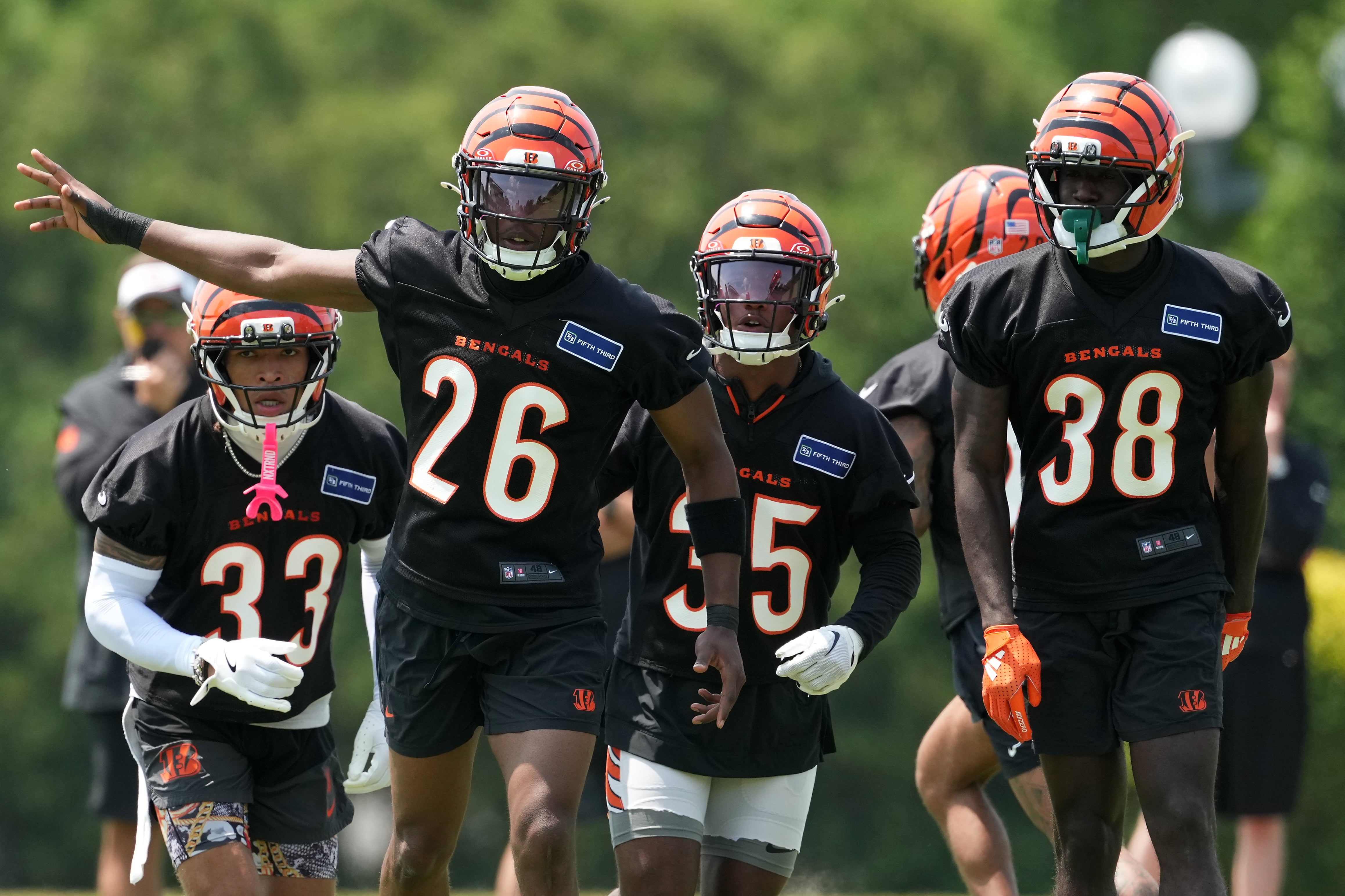 Jun 10, 2025; Cincinnati, OH, USA; Cincinnati Bengals safety Daijahn Anthony (33), safety Tycen Anderson (26), cornerback Jalen Davis (35) and cornerback DJ Ivey (38) take the field during practice at Paycor Stadium.