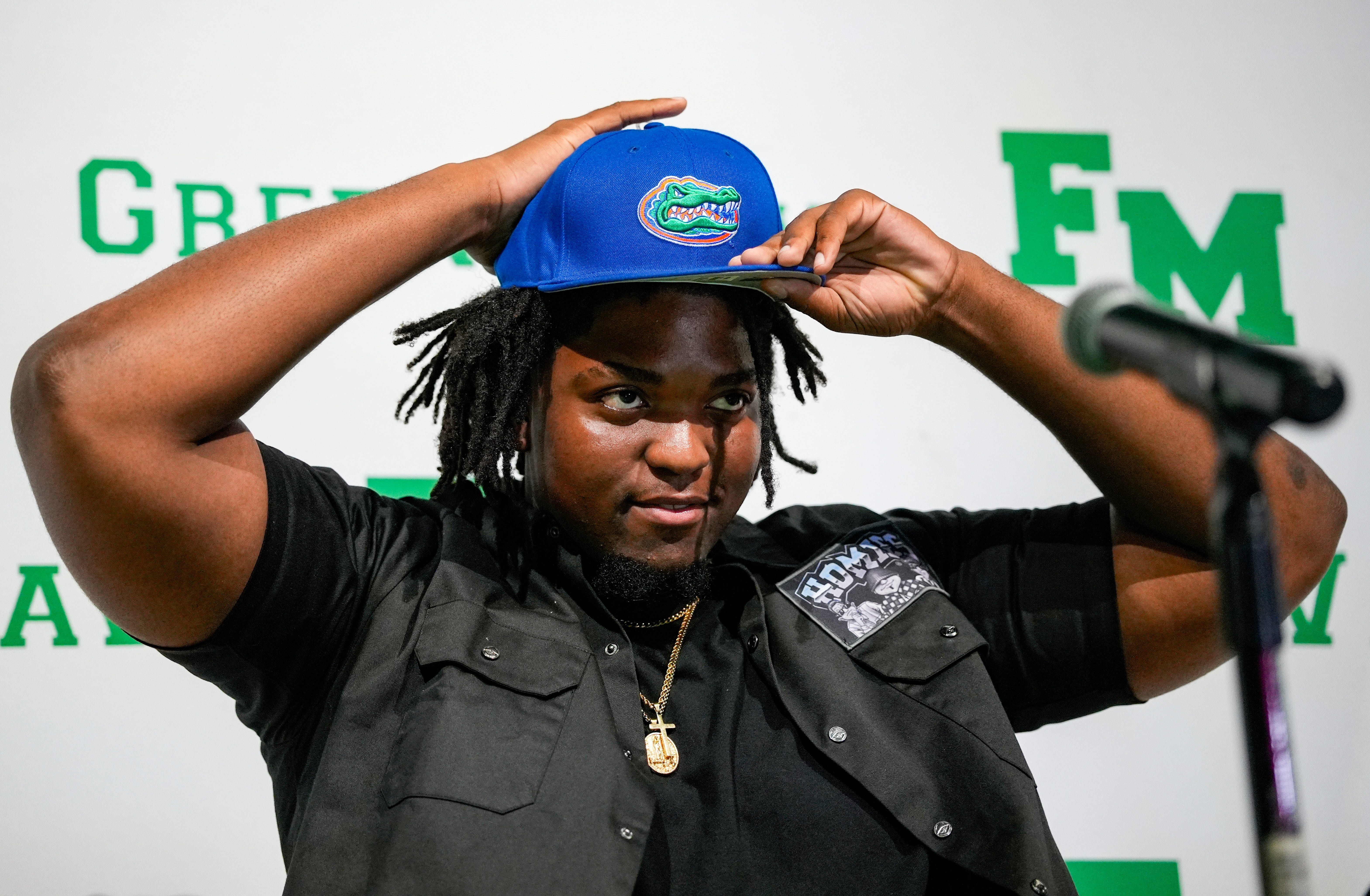 Fort Myers Green Wave defensive lineman Kendall Guervil commits to the University of Florida while surrounded by friends and family during a ceremony at Fort Myers High School in Fort Myers, Fla., on Wednesday, July 2, 2025.
