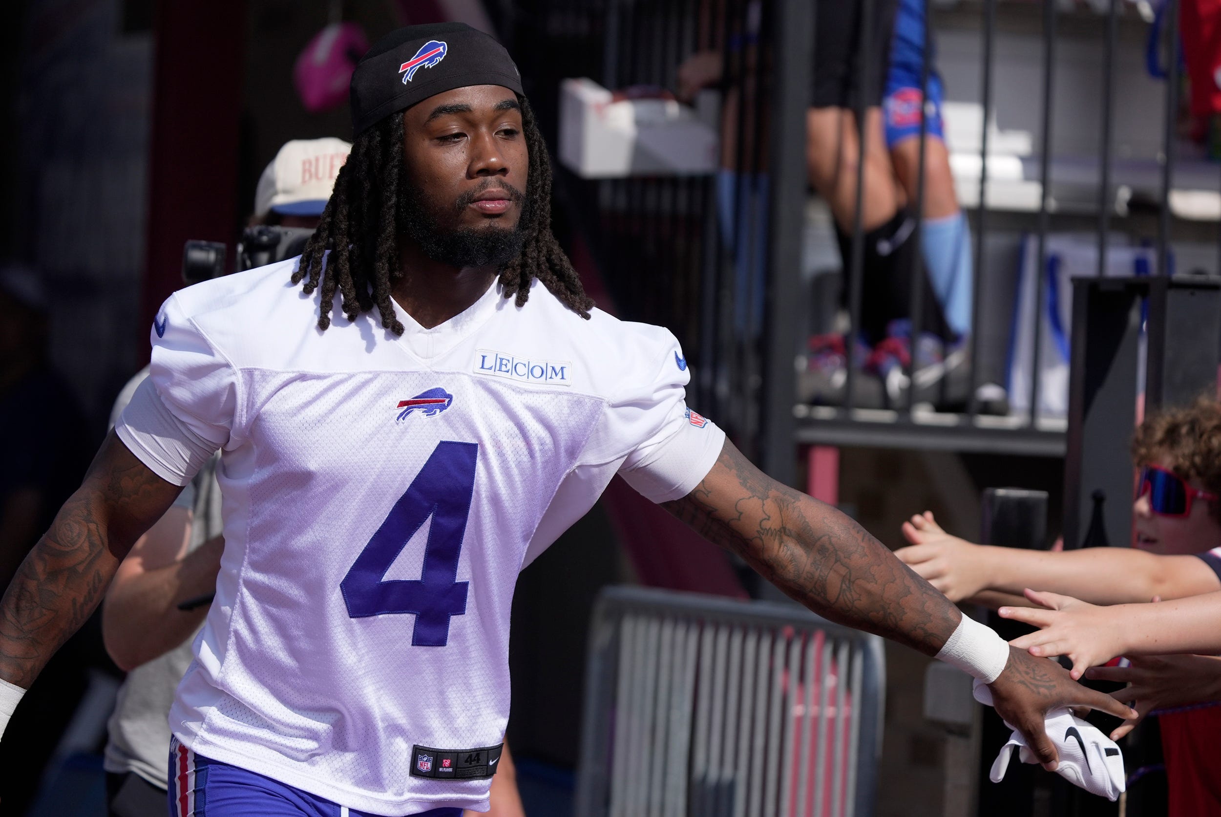 Buffalo Bills running back James Cook runs by slapping hands with out held hands as he heads to the field during the Buffalo Bills training camp at St. John Fisher University in Pittsford on July 24, 2025.