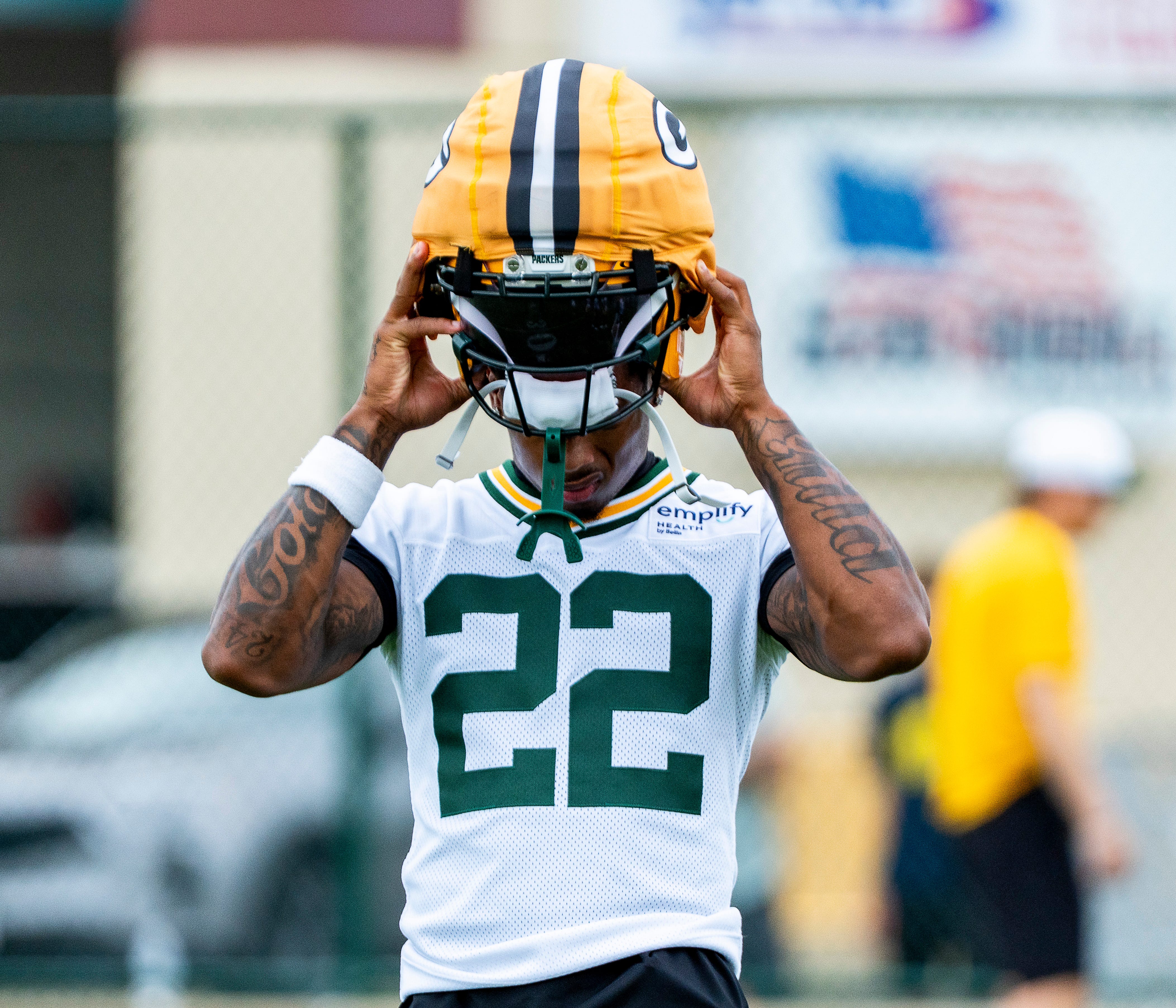 Green Bay Packers wide receiver Matthew Golden (22) puts on his helmet, preparing to run through a drill during the second day of training camp on Thursday, July 24, 2025, at Ray Nitschke Field in Ashwaubenon, Wis.