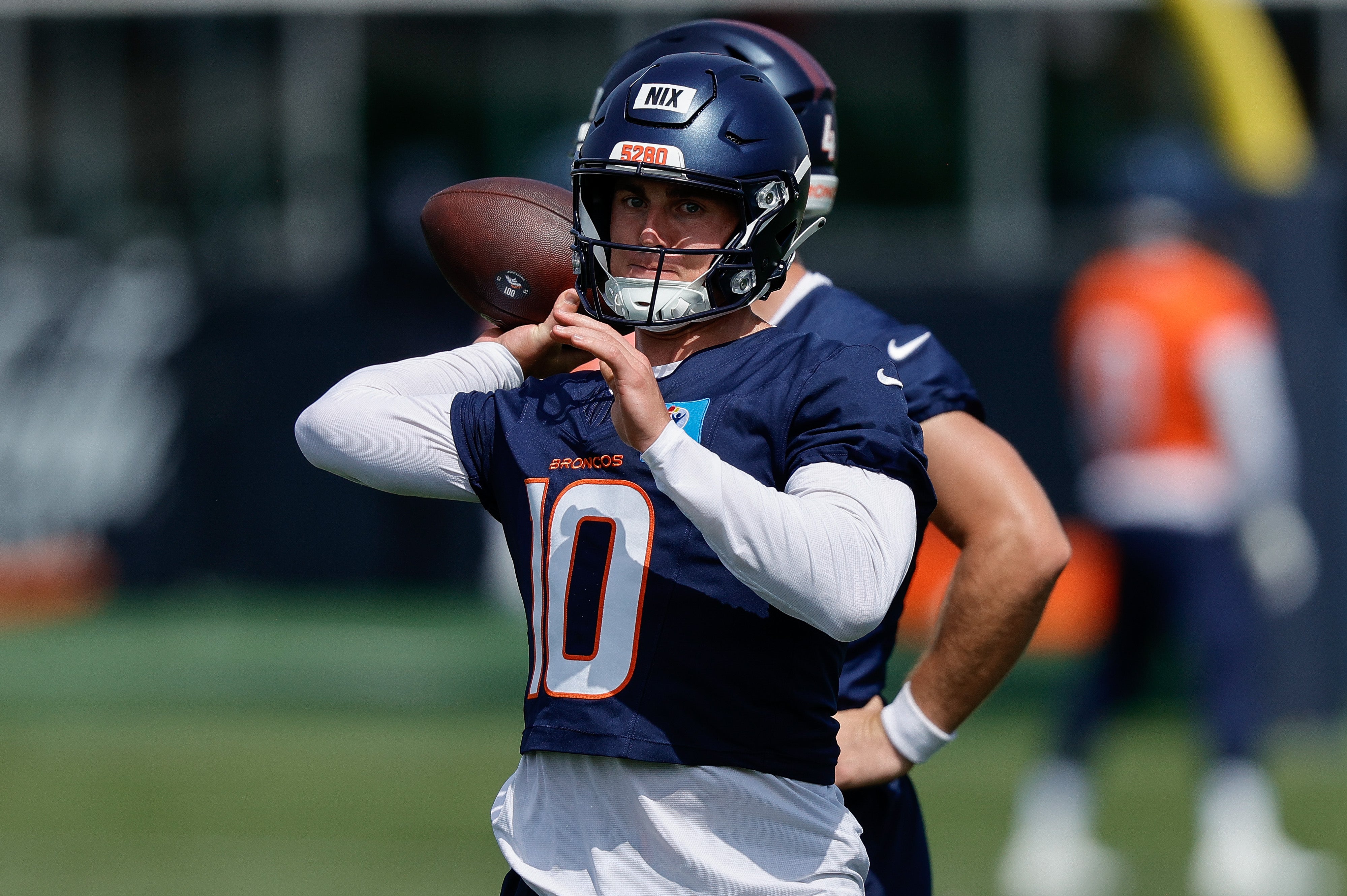 Denver Broncos QB Bo Nix participating in drills during training camp