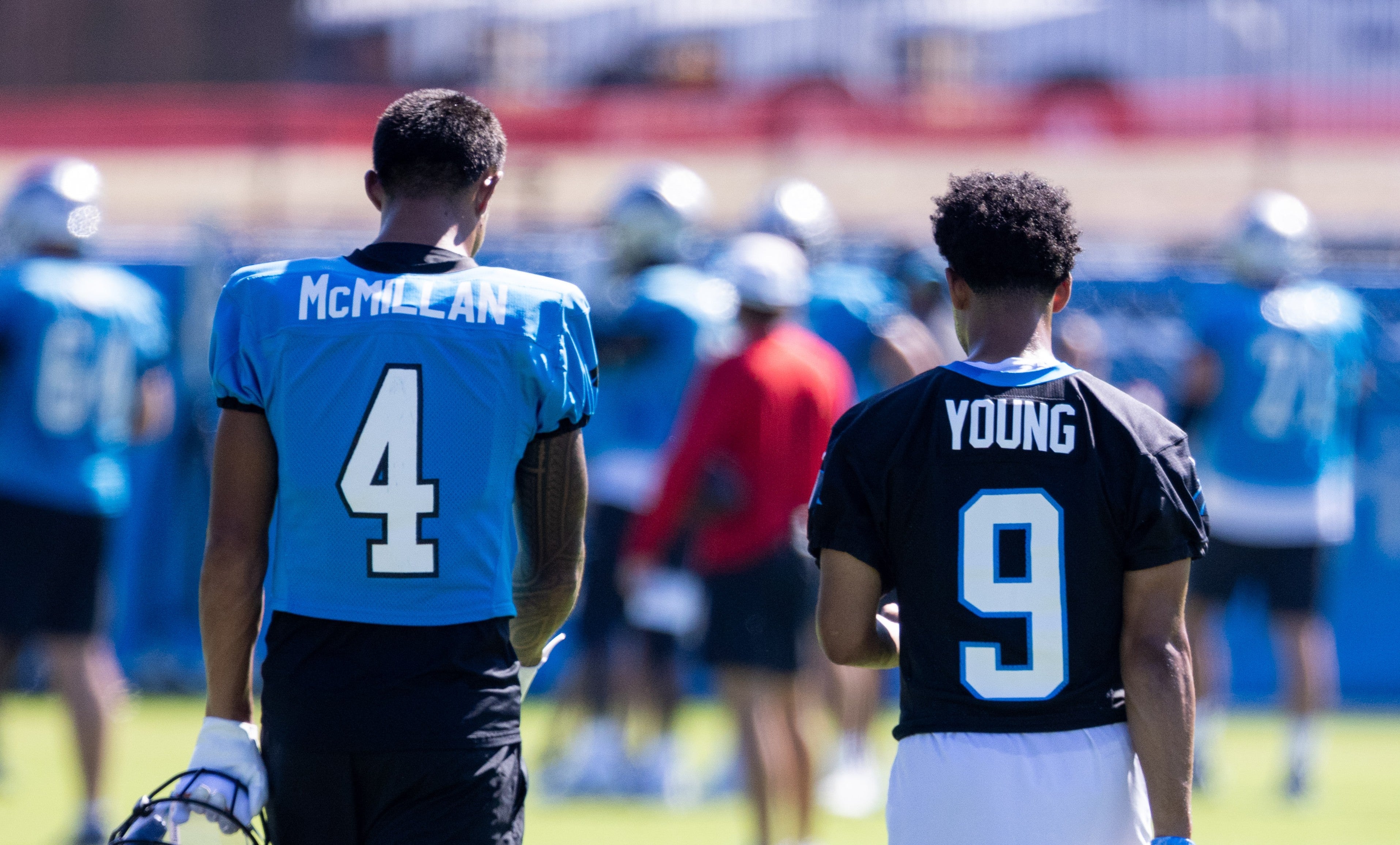Jul 26, 2025; Charlotte, NC, USA; Carolina Panthers wide receiver Tetairoa McMillan (4) and quarterback Bryce Young (9) talk as they head to stretch during training camp.
