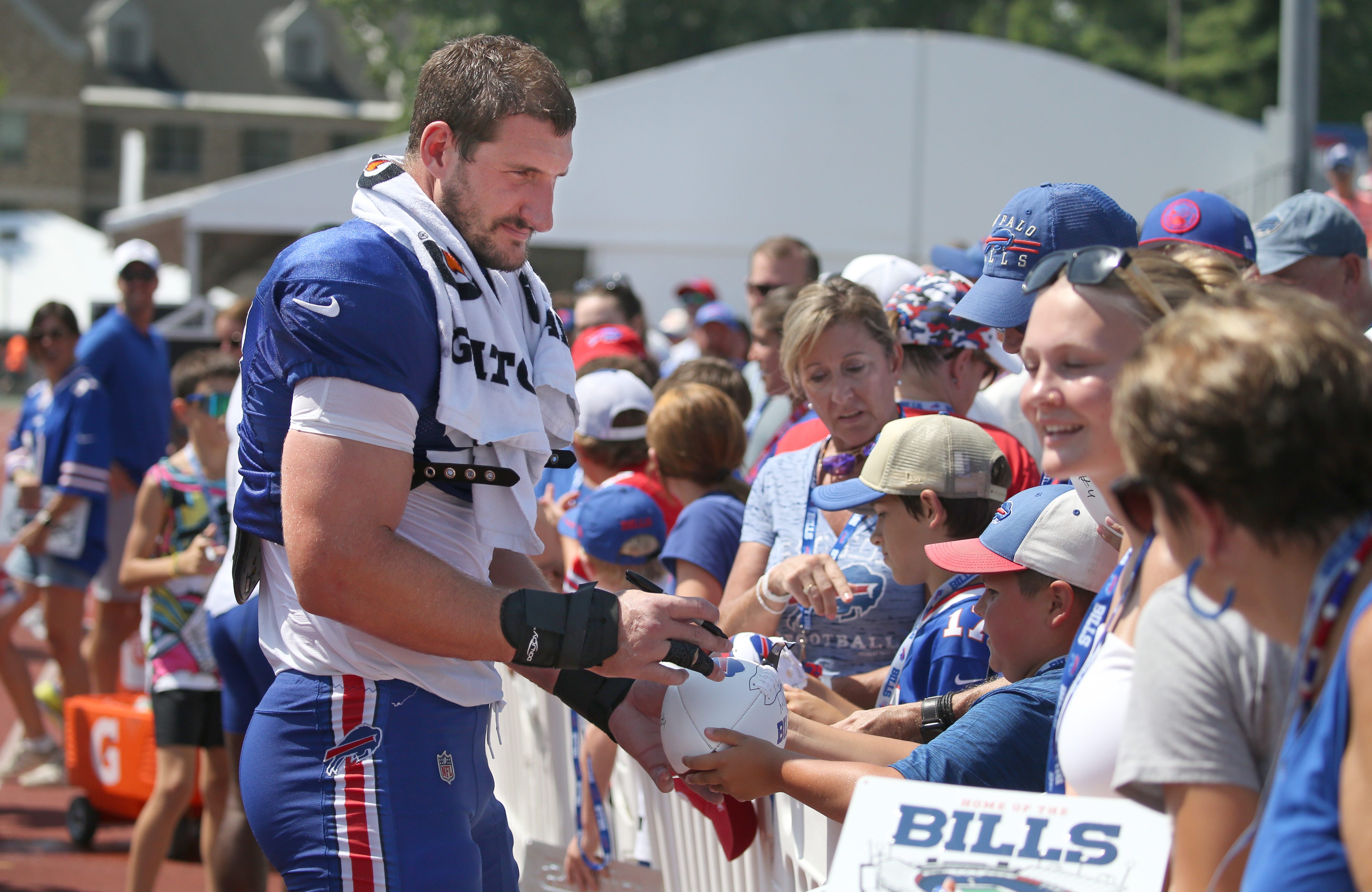 Buffalo Bills pass rusher Joey Bosa takes the time after practice to sign autographs for the Bills Mafia