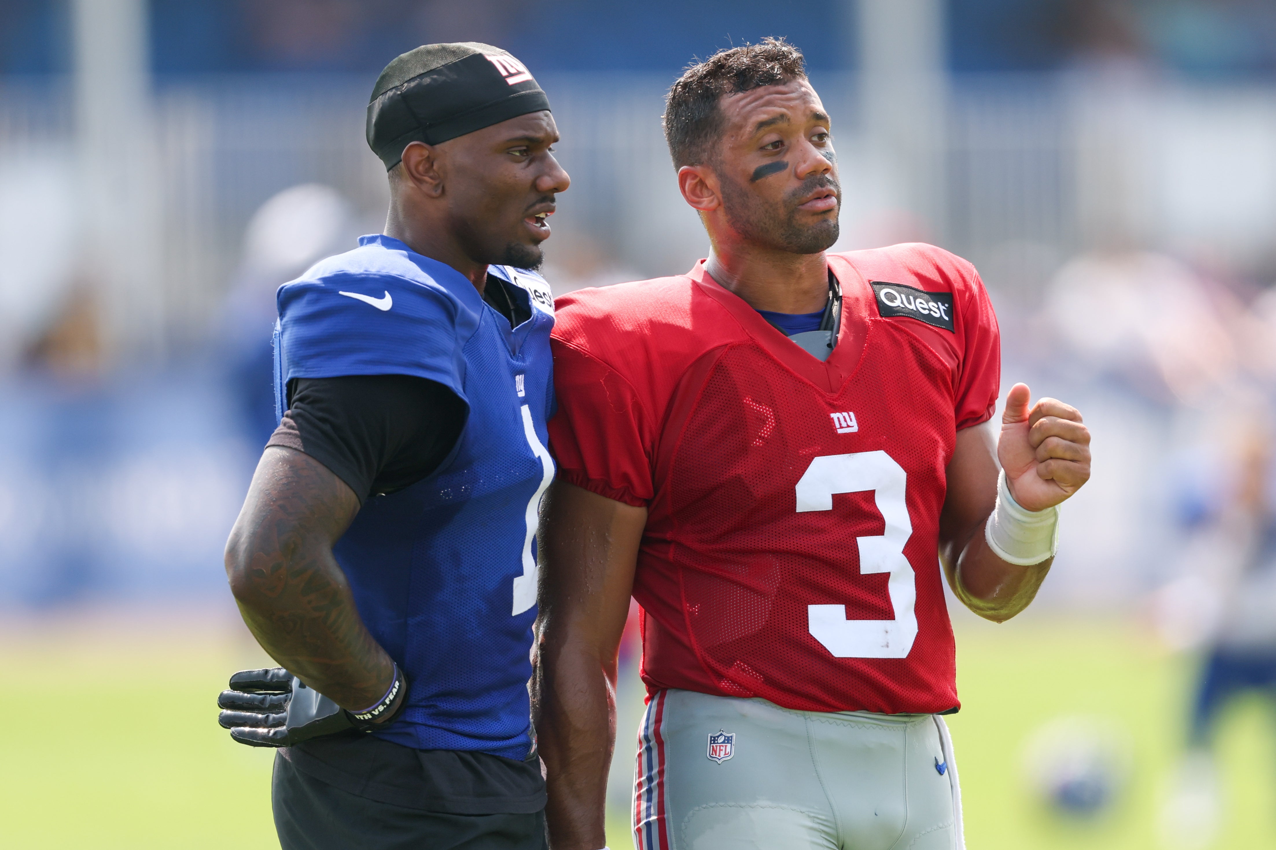 Aug 4, 2025; East Rutherford, NJ, USA; New York Giants wide receiver Malik Nabers (1) talks with quarterback Russell Wilson (3) during training camp at Quest Diagnostics Training Center.