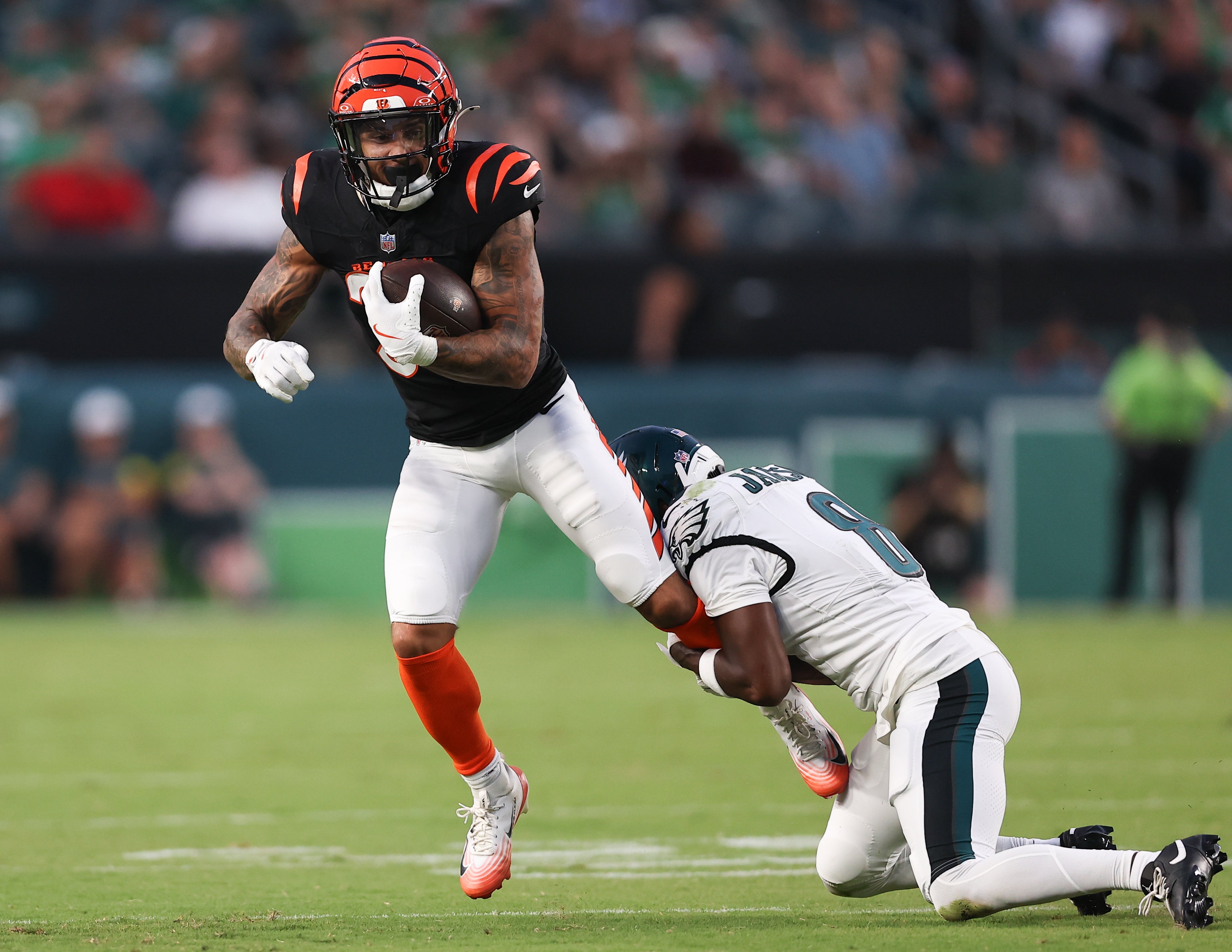 Philadelphia Eagles cornerback Adoree' Jackson (8) tackles Cincinnati Bengals running back Chase Brown (30) after his catch during the first quarter at Lincoln Financial Field. Bill Streicher-Imagn Images