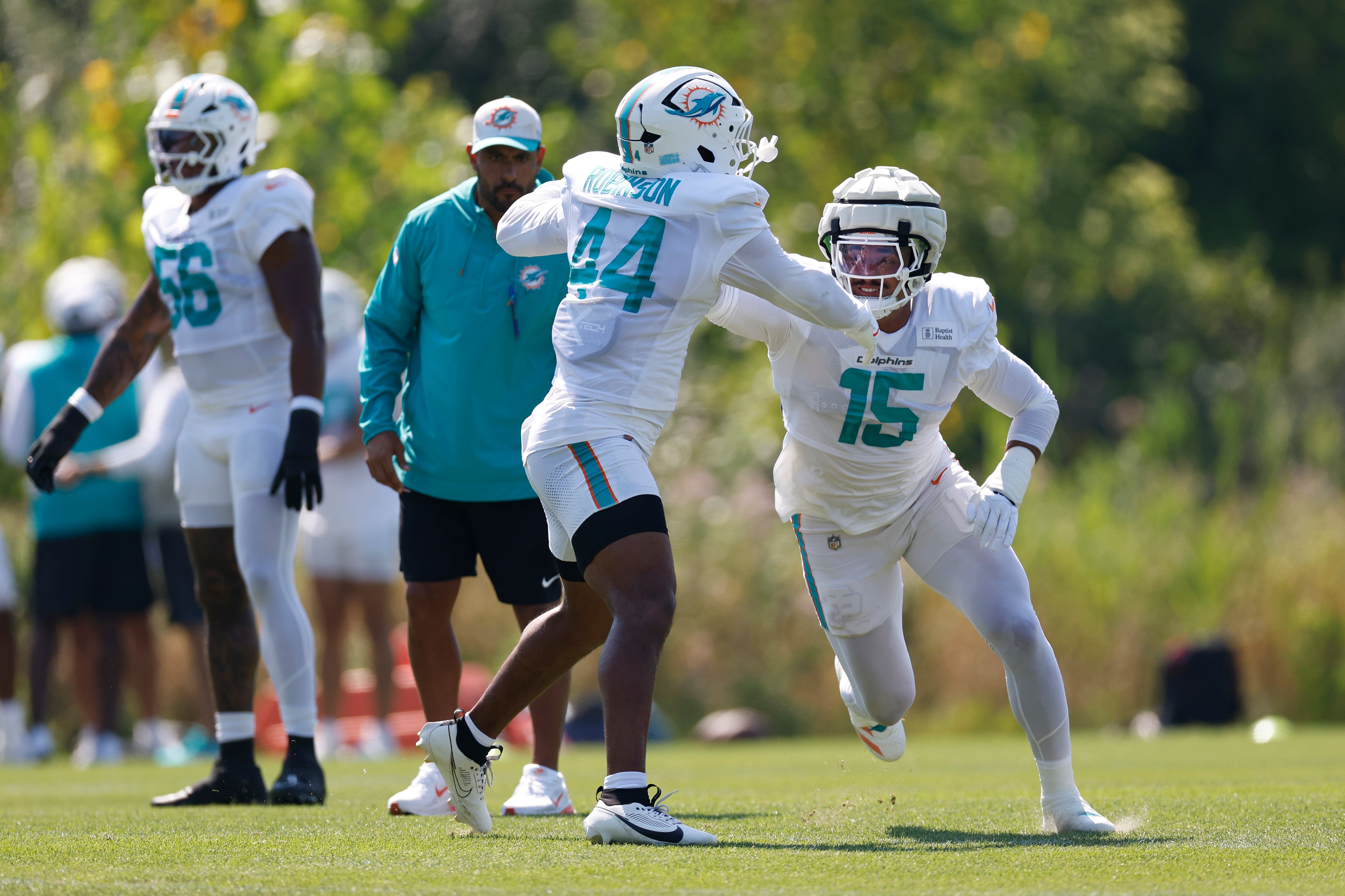 Aug 8, 2025; Lake Forest, IL, USA; Miami Dolphins linebacker Chop Robinson (44) and linebacker Jaelan Phillips (15) run on the field before joint training camp practice with the Chicago Bears ahead of Sunday's preseason opener.
