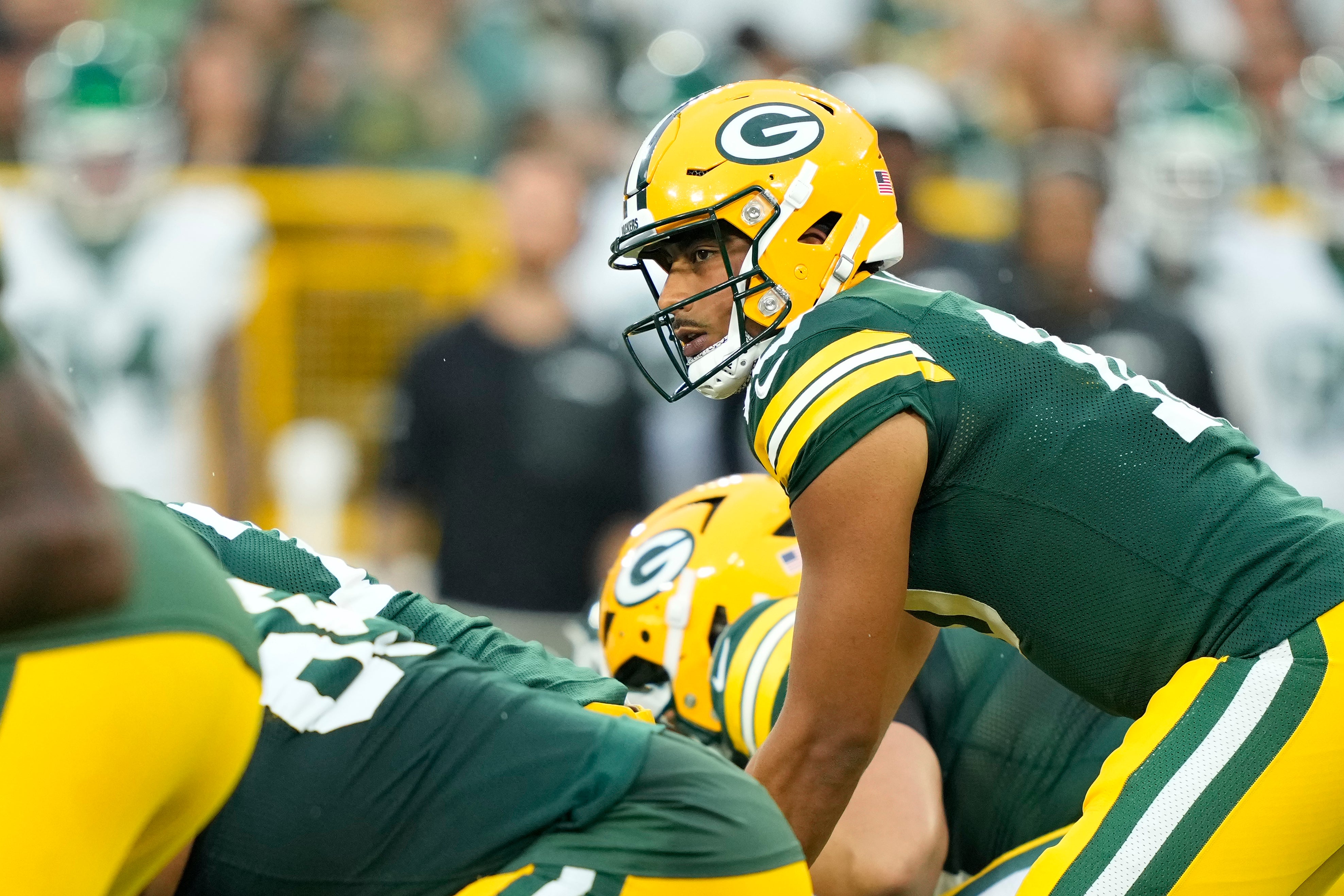 Aug 9, 2025; Green Bay, Wisconsin, USA; Green Bay Packers quarterback Jordan Love (10) lines up for the snap against the New York Jets during the first quarter at Lambeau Field.