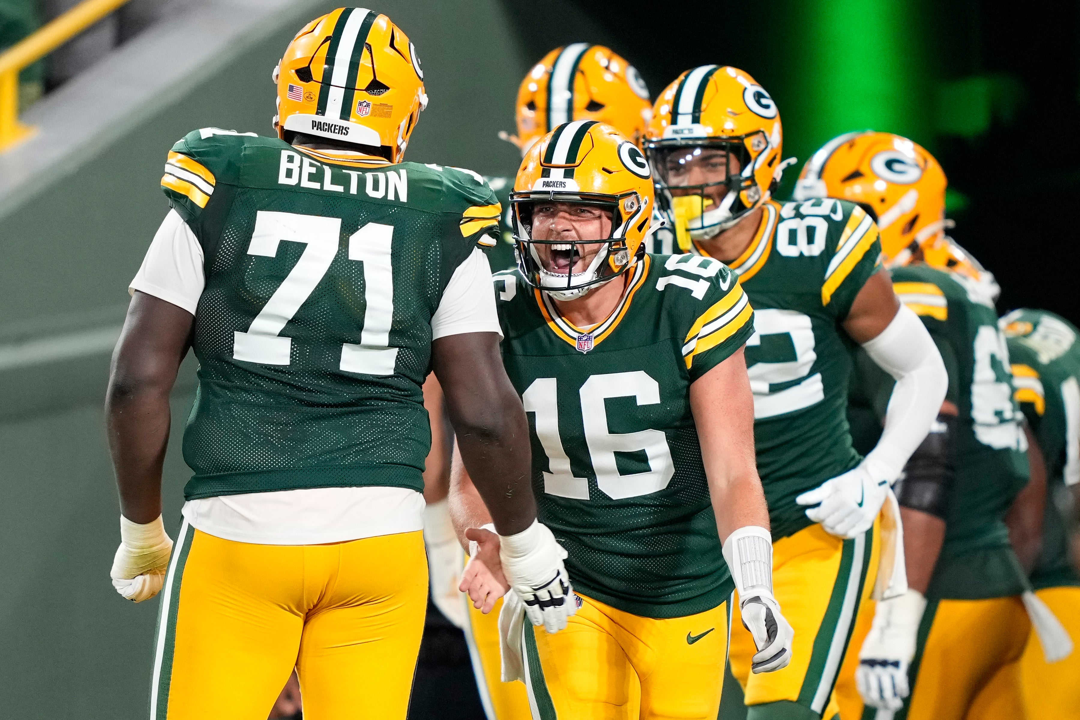 Aug 9, 2025; Green Bay, Wisconsin, USA; Green Bay Packers quarterback Sean Clifford (16) reacts to a touchdown with offensive tackle Anthony Belton (71) during the second half against the New York Jets at Lambeau Field.