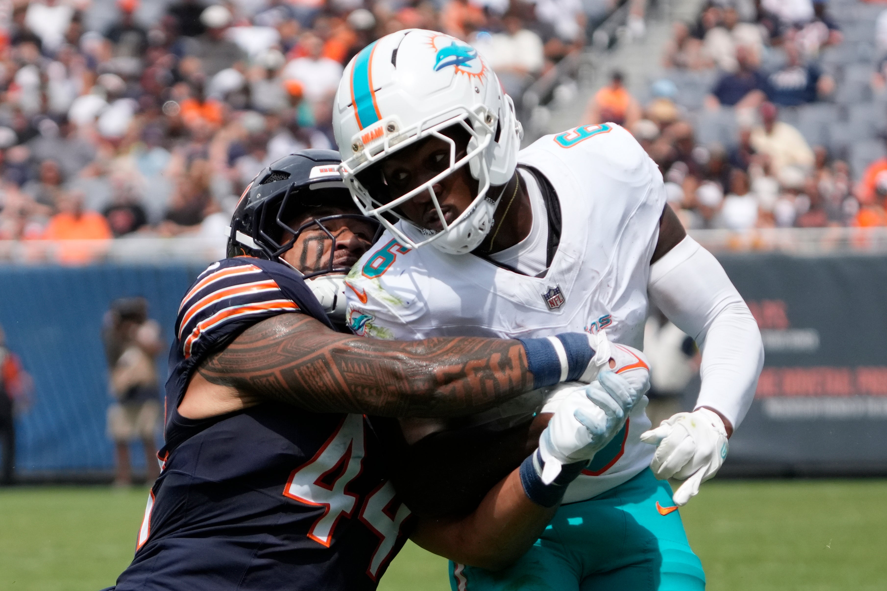 Aug 10, 2025; Chicago, Illinois, USA; Chicago Bears linebacker Noah Sewell (44) defends Miami Dolphins wide receiver Malik Washington (6) during the first half at Soldier Field.