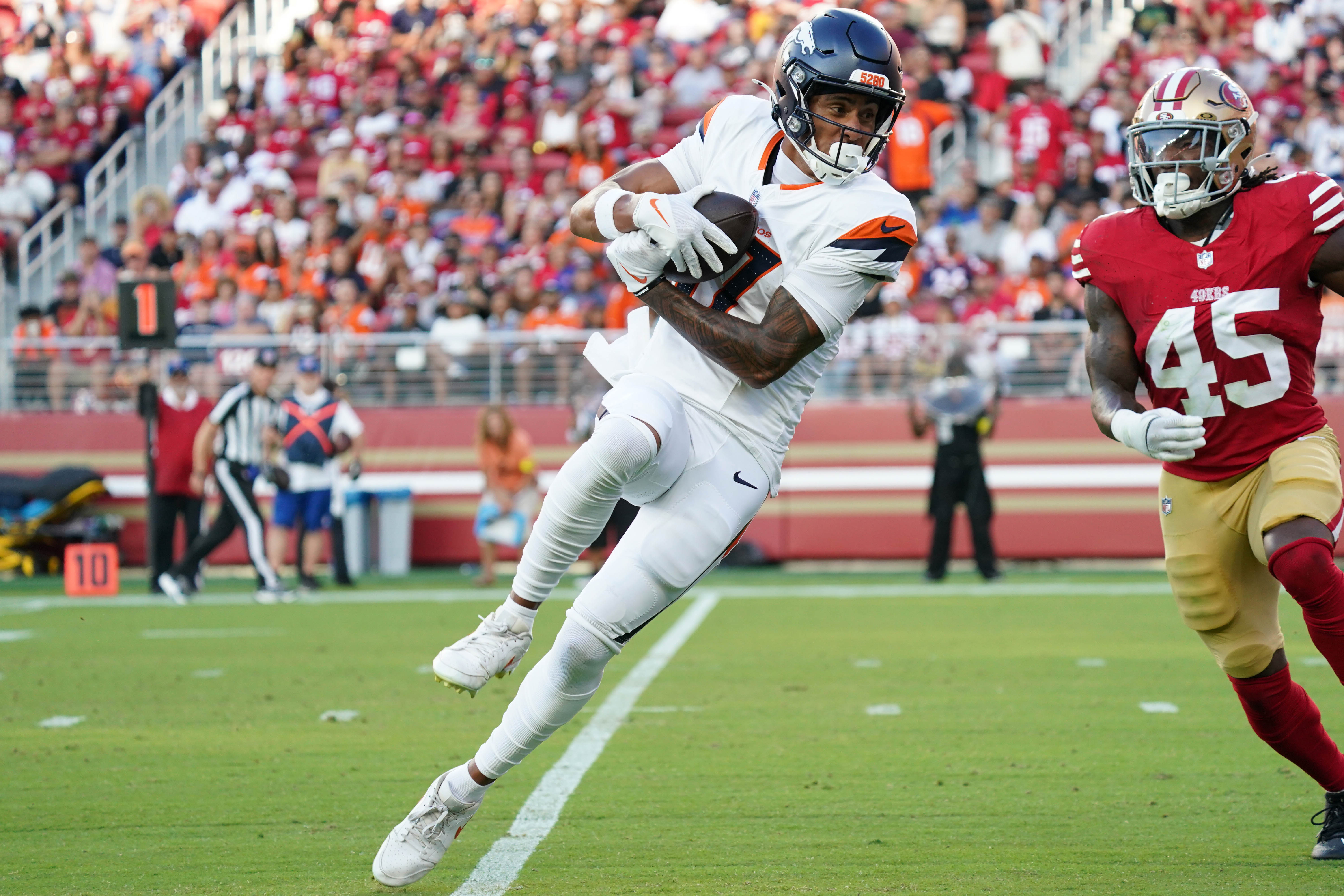 Denver Broncos receiver Devaughn Vele catches a pass