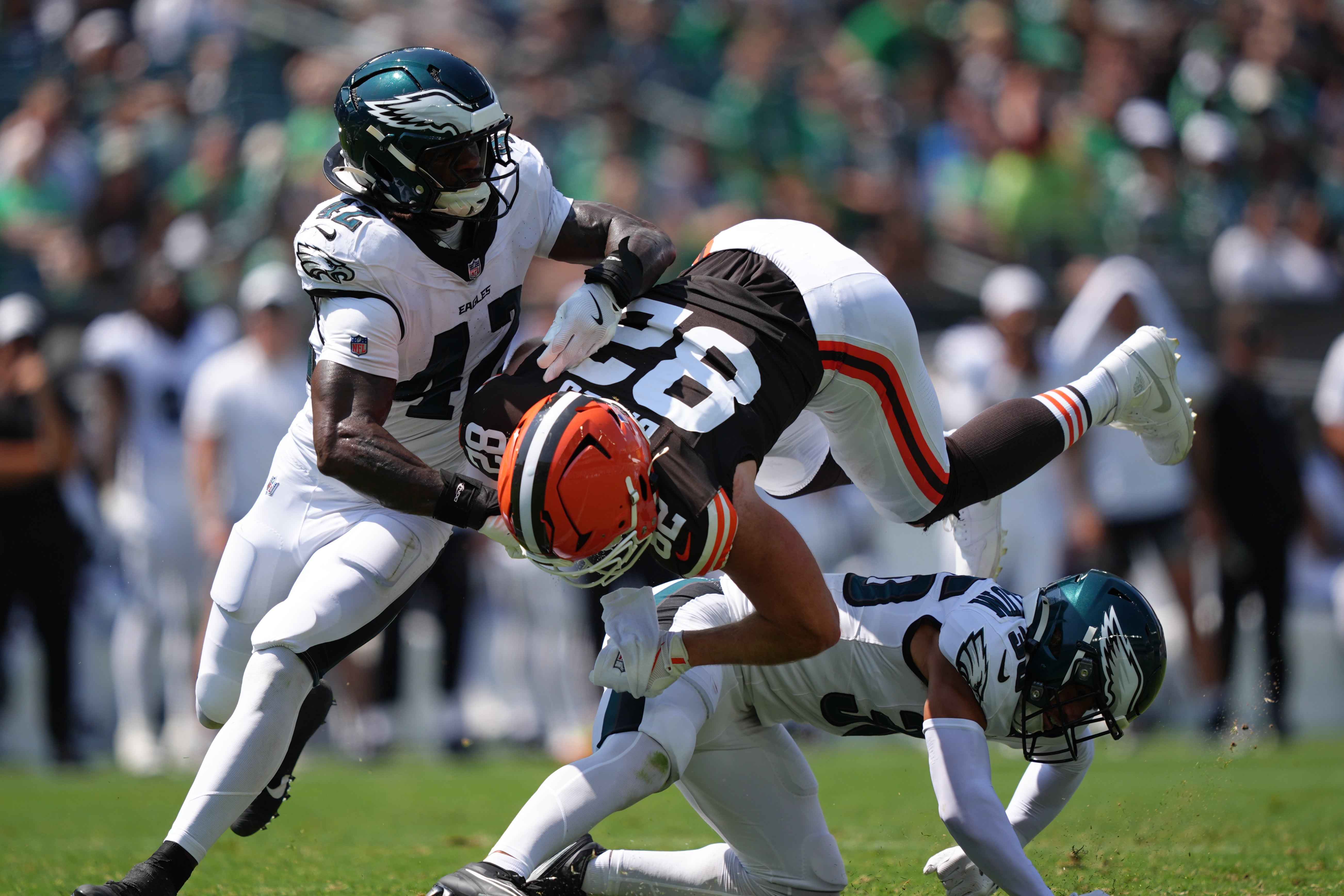 Philadelphia Eagles safety Tristin McCollum (36) and linebacker Smael Mondon (42) tackle Cleveland Browns tight end Brenden Bates (82) in the first half at Lincoln Financial Field. Kyle Ross-Imagn Images
