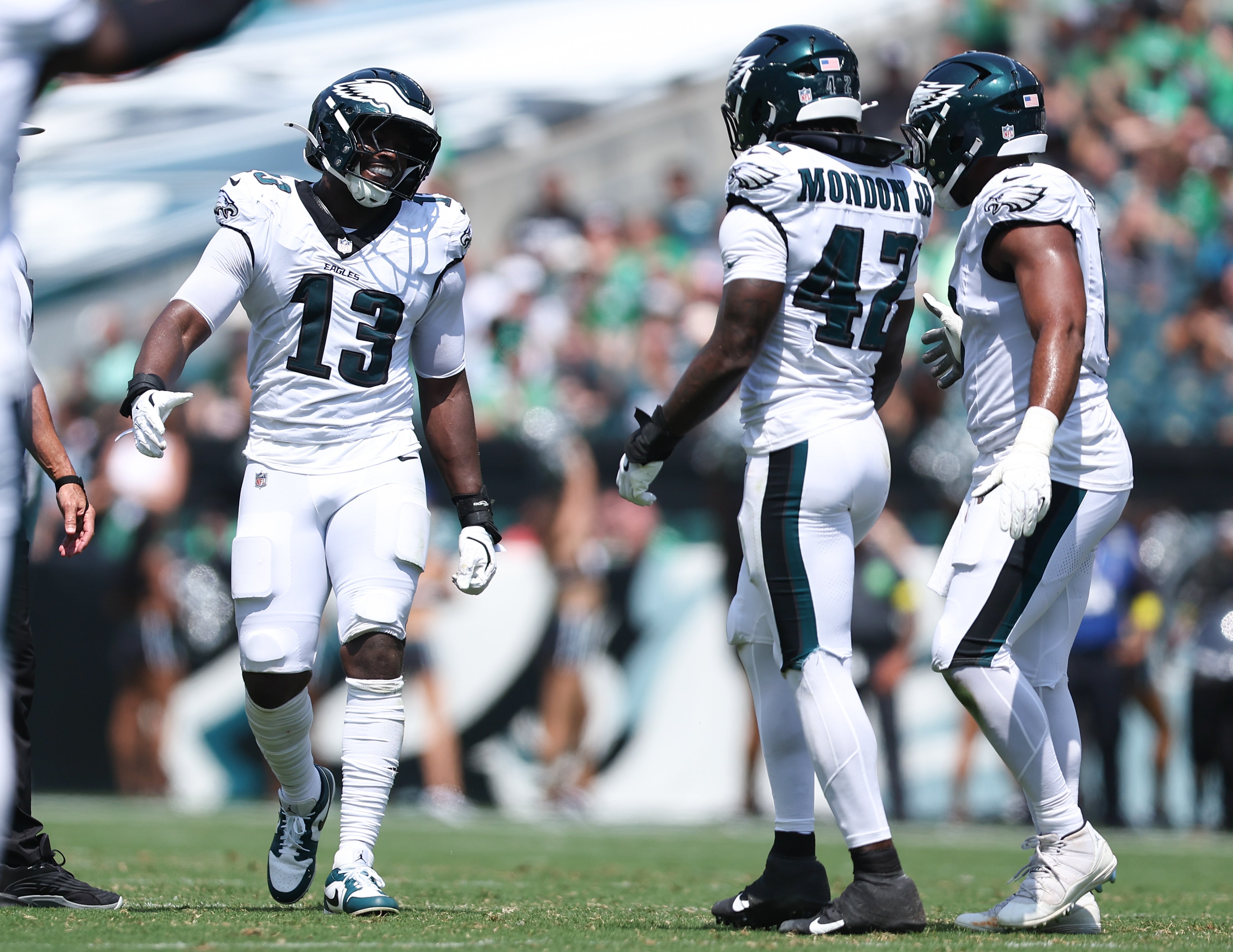 Philadelphia Eagles linebacker Azeez Ojulari (13) reacts with linebacker Smael Mondon Jr. (42) after a tackle during the second quarter at Lincoln Financial Field. Bill Streicher-Imagn Images
