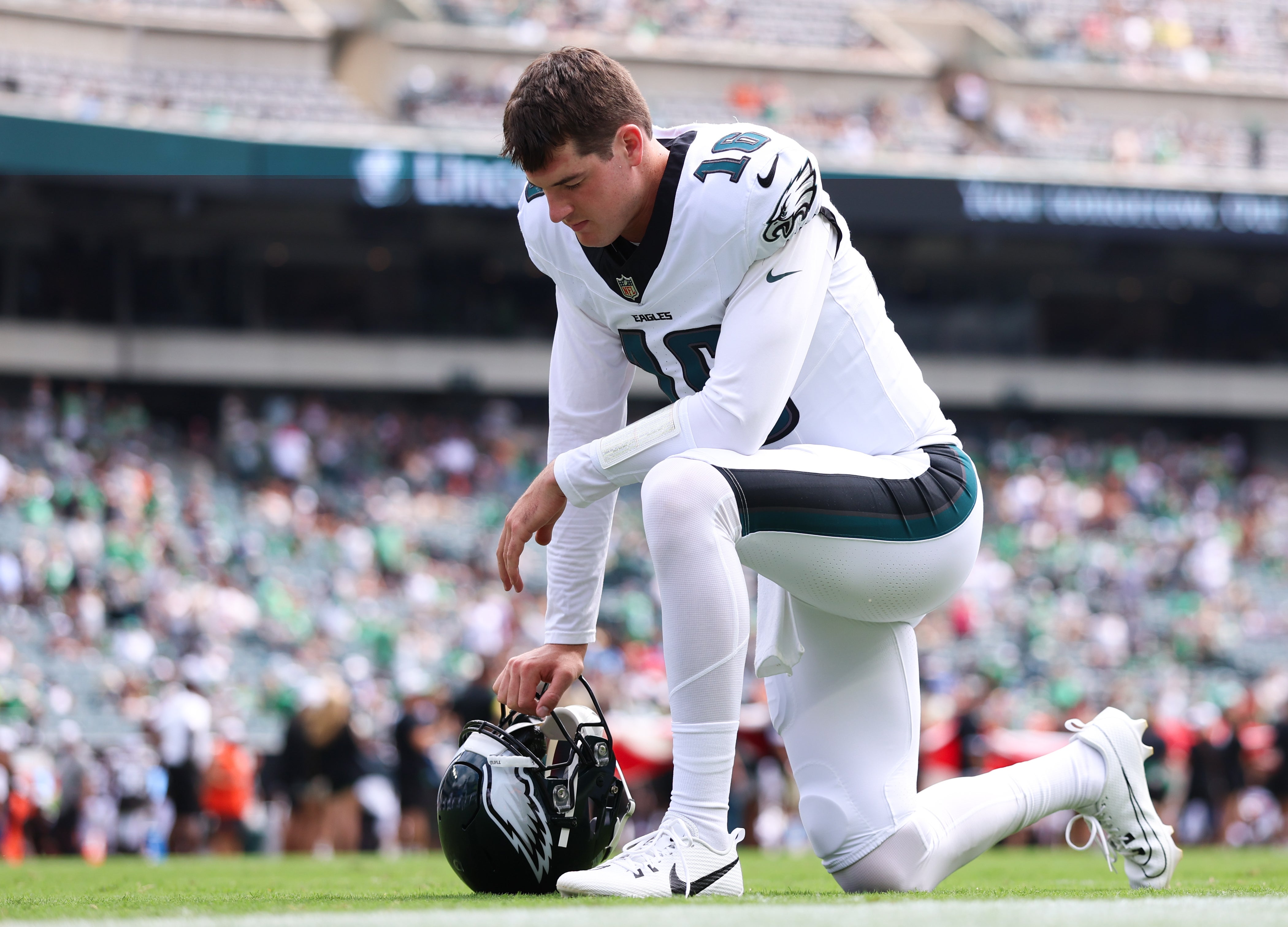 Philadelphia Eagles quarterback Tanner McKee (16) kneels on the field before a game against the Cleveland Browns at Lincoln Financial Field. Bill Streicher-Imagn Images