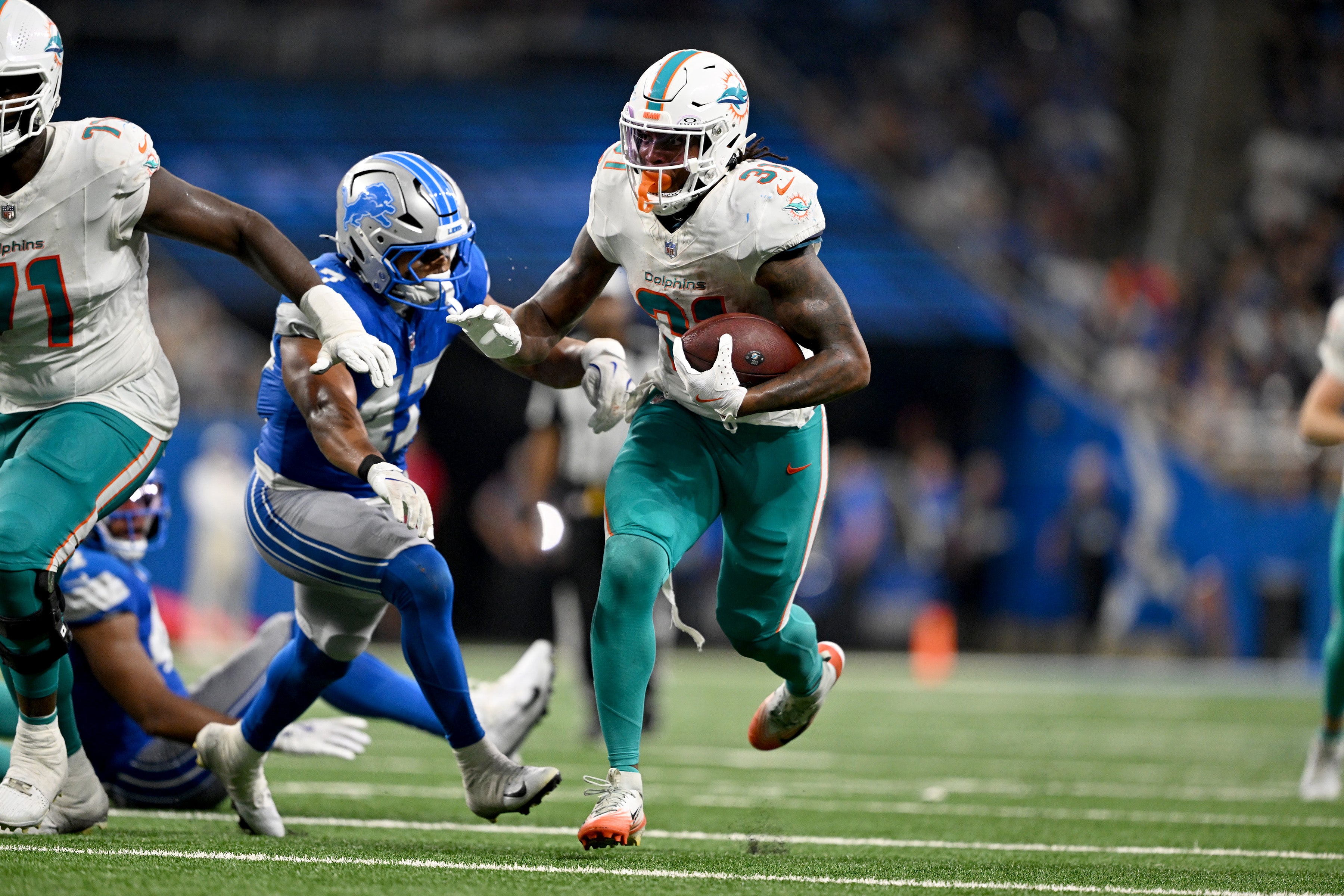 Aug 16, 2025; Detroit, Michigan, USA; Miami Dolphins running back Ollie Gordon II (31) runs the ball against the Detroit Lions against the Miami Dolphins in the fourth quarter at Ford Field.