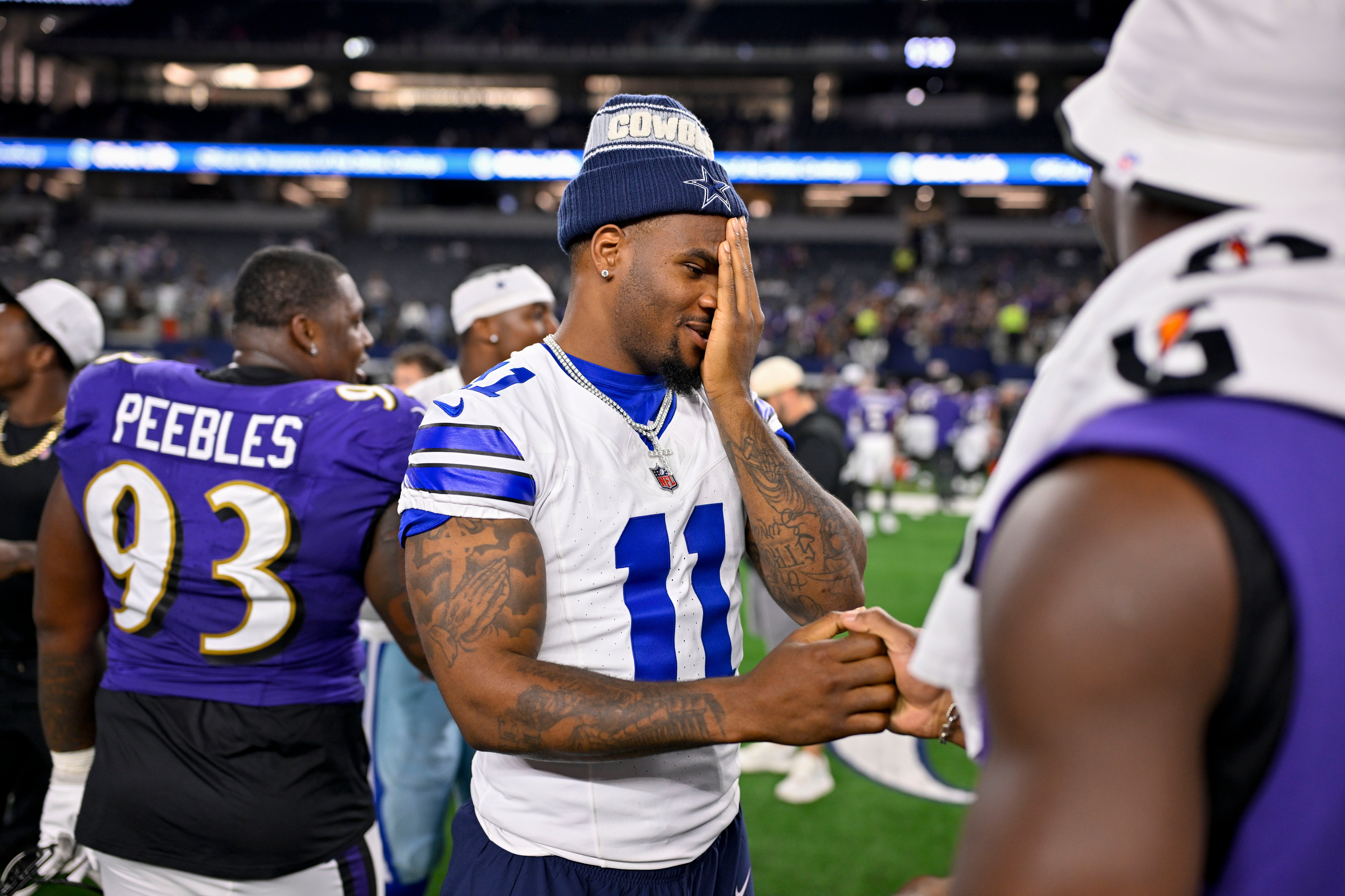 Dallas Cowboys defensive end Micah Parsons (11) talks with Baltimore Ravens linebacker Odafe Oweh (99) after the game at AT&T Stadium.