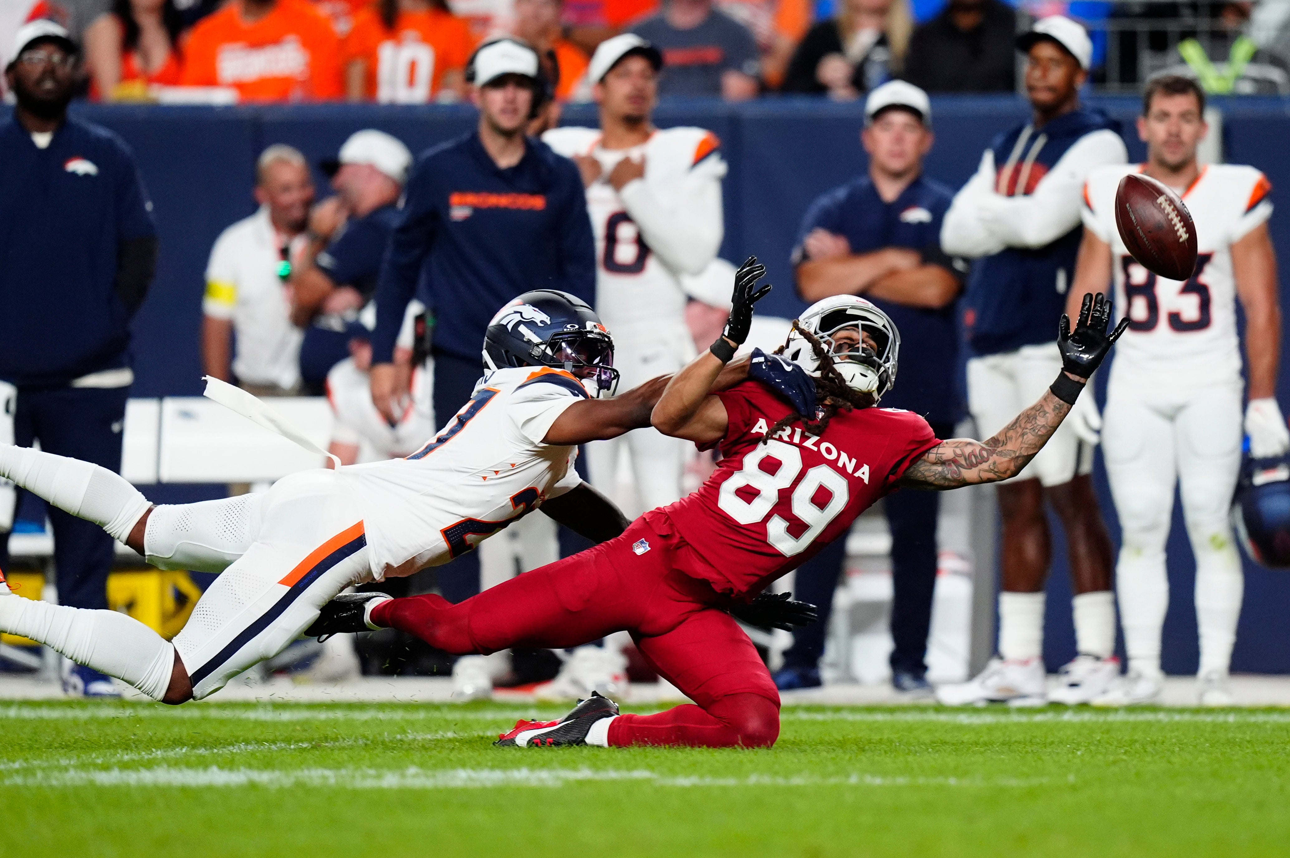 Aug 16, 2025; Denver, Colorado, USA; Denver Broncos cornerback Damarri Mathis (27) defends on Arizona Cardinals wide receiver Xavier Weaver (89) in the second quarter at Empower Field at Mile High.