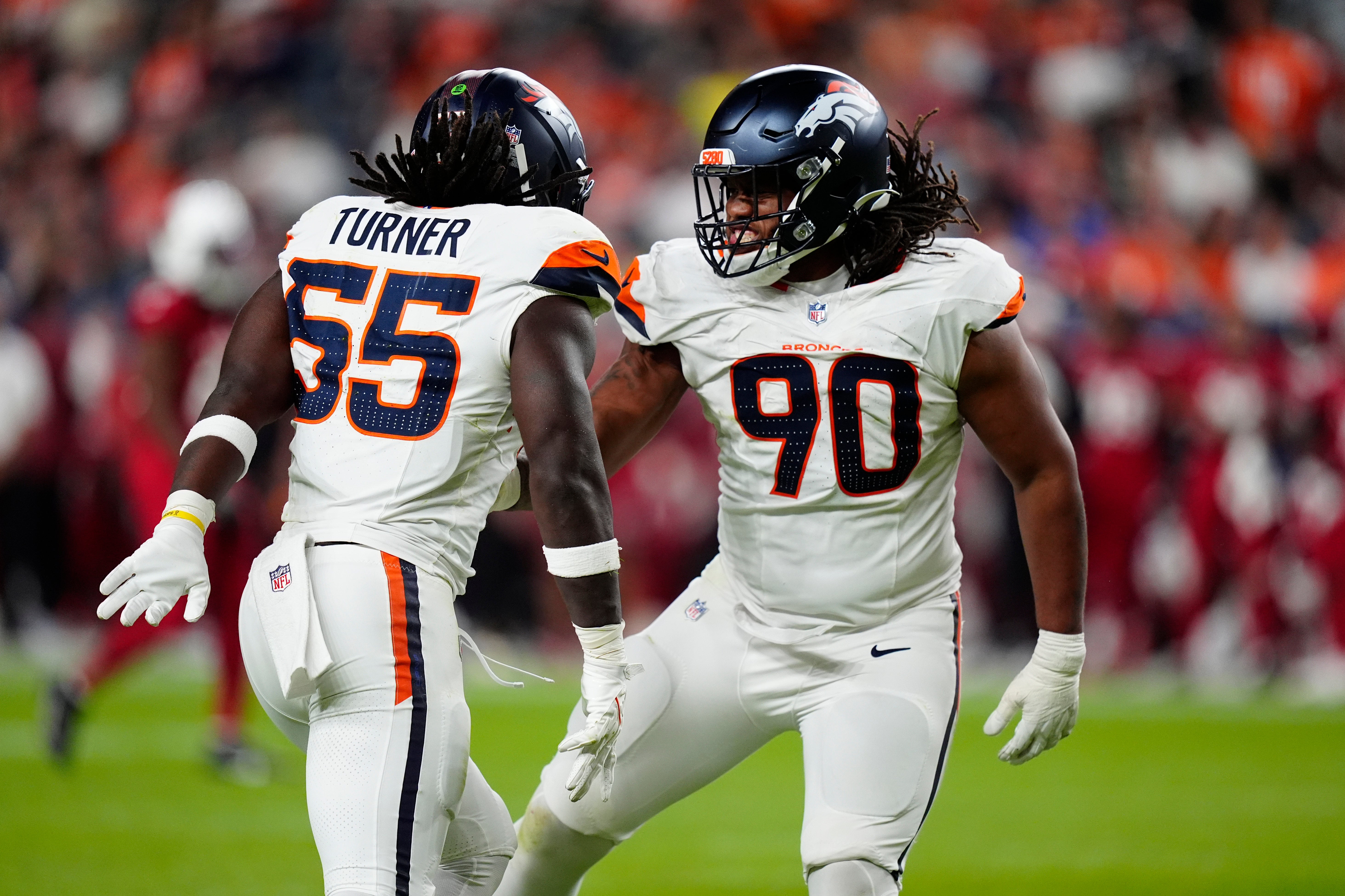 Aug 16, 2025; Denver, Colorado, USA; Denver Broncos linebacker Jordan Turner (55) celebrates his sack with defensive tackle Jordan Miller (90) in the second half against the Arizona Cardinals at Empower Field at Mile High.