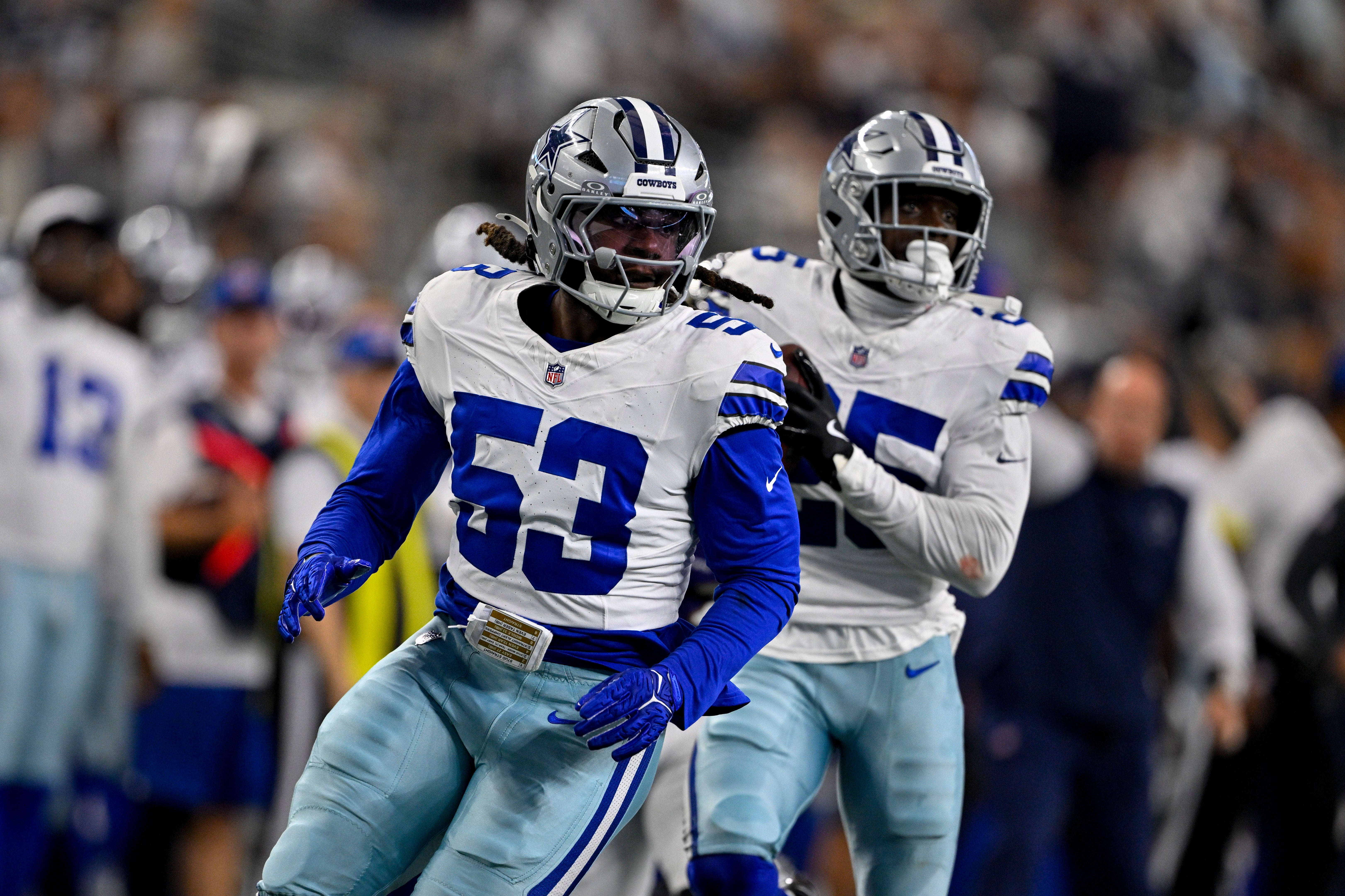 Arlington, Texas, USA; Dallas Cowboys linebacker James Houston (53) and cornerback Andrew Booth (25) return an interception for a touchdown during the game between the Dallas Cowboys and the Baltimore Ravens at AT&T Stadium.