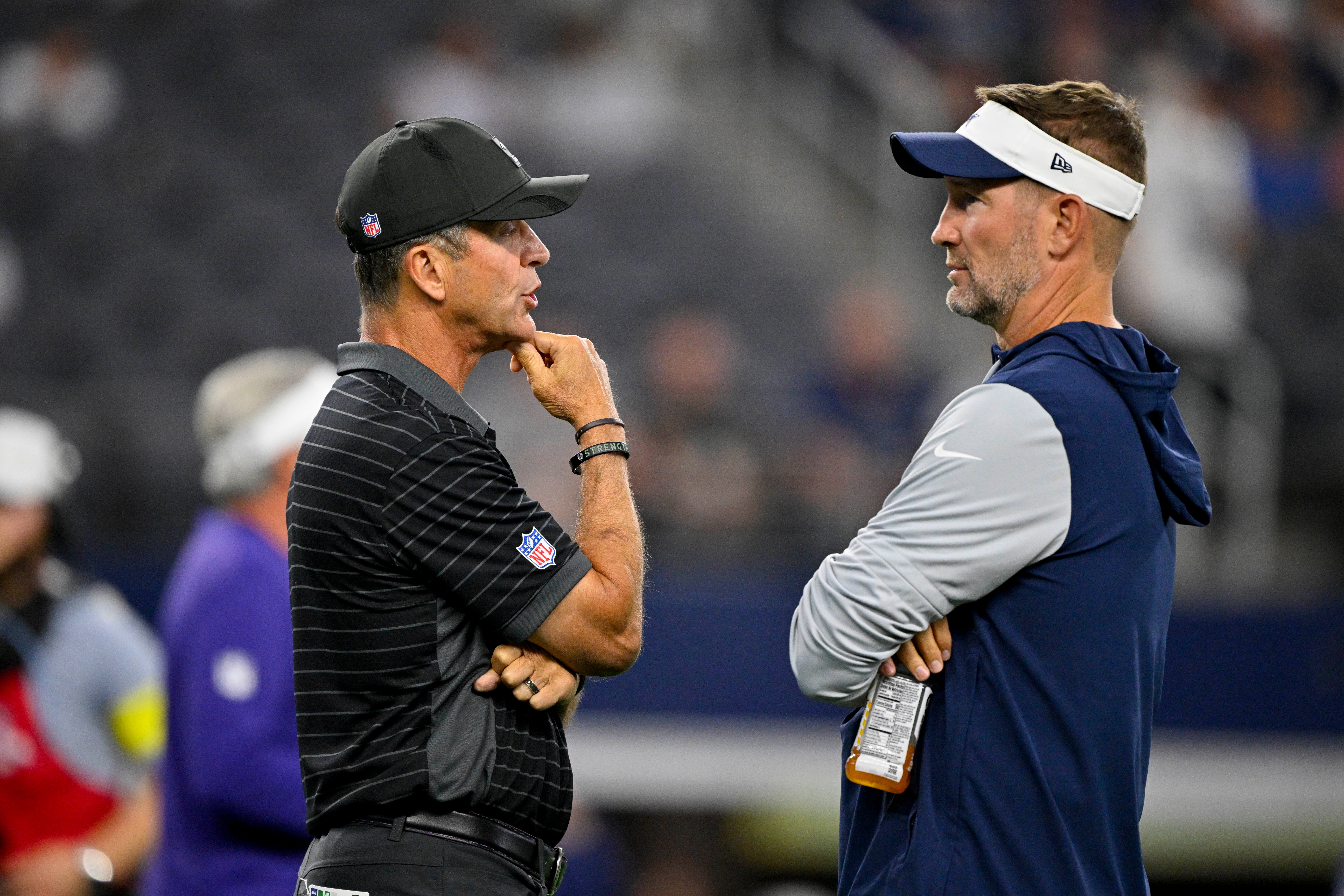 Baltimore Ravens head coach John Harbaugh (left) and Dallas Cowboys head coach Brian Schottenheimer (right) before the game between the Dallas Cowboys and the Baltimore Ravens at AT&T Stadium.