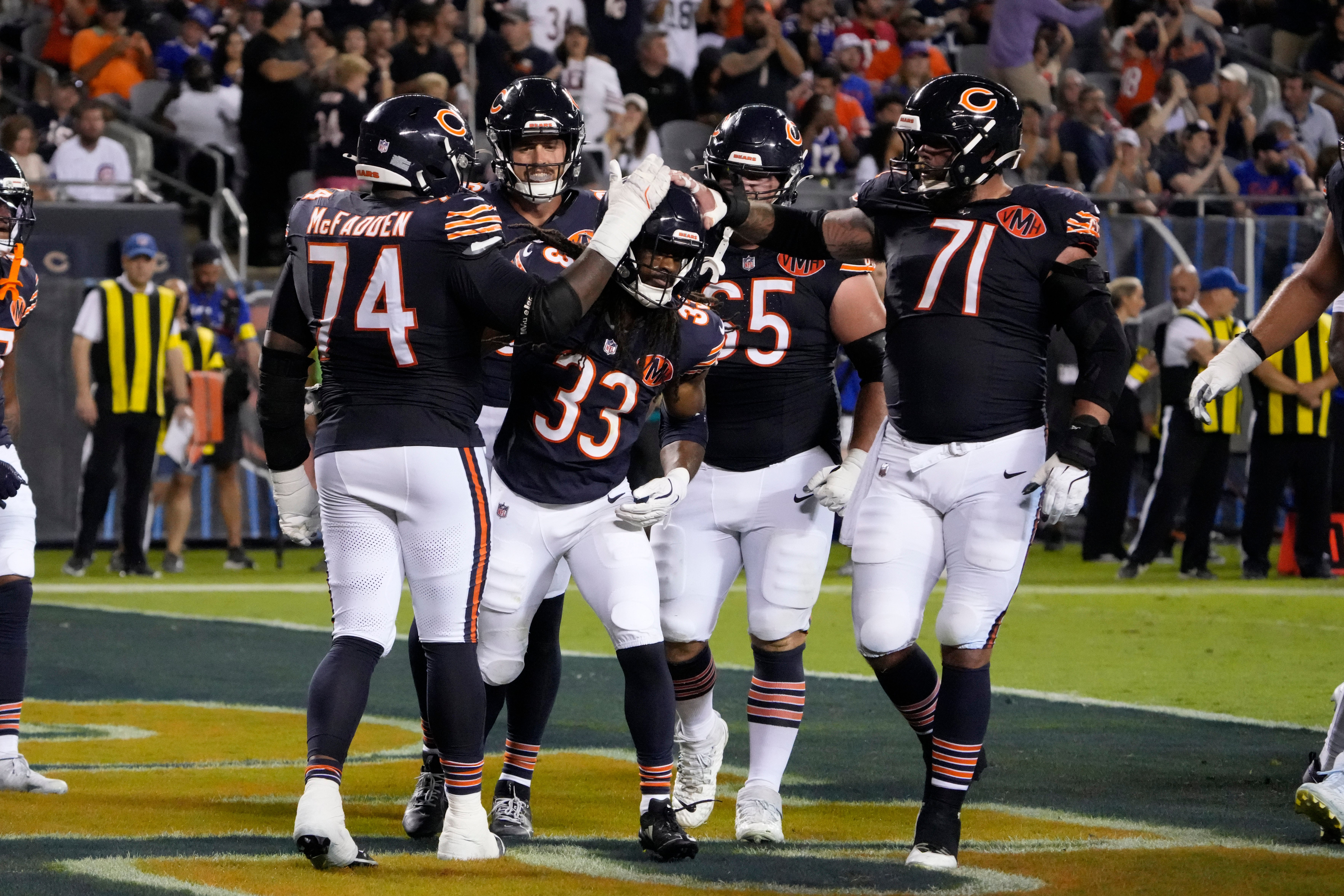 Aug 17, 2025; Chicago, Illinois, USA; Chicago Bears running back Ian Wheeler (33) celebrates his touchdown against the Buffalo Bills with guard Jordan McFadden (74) during the first half at Soldier Field.