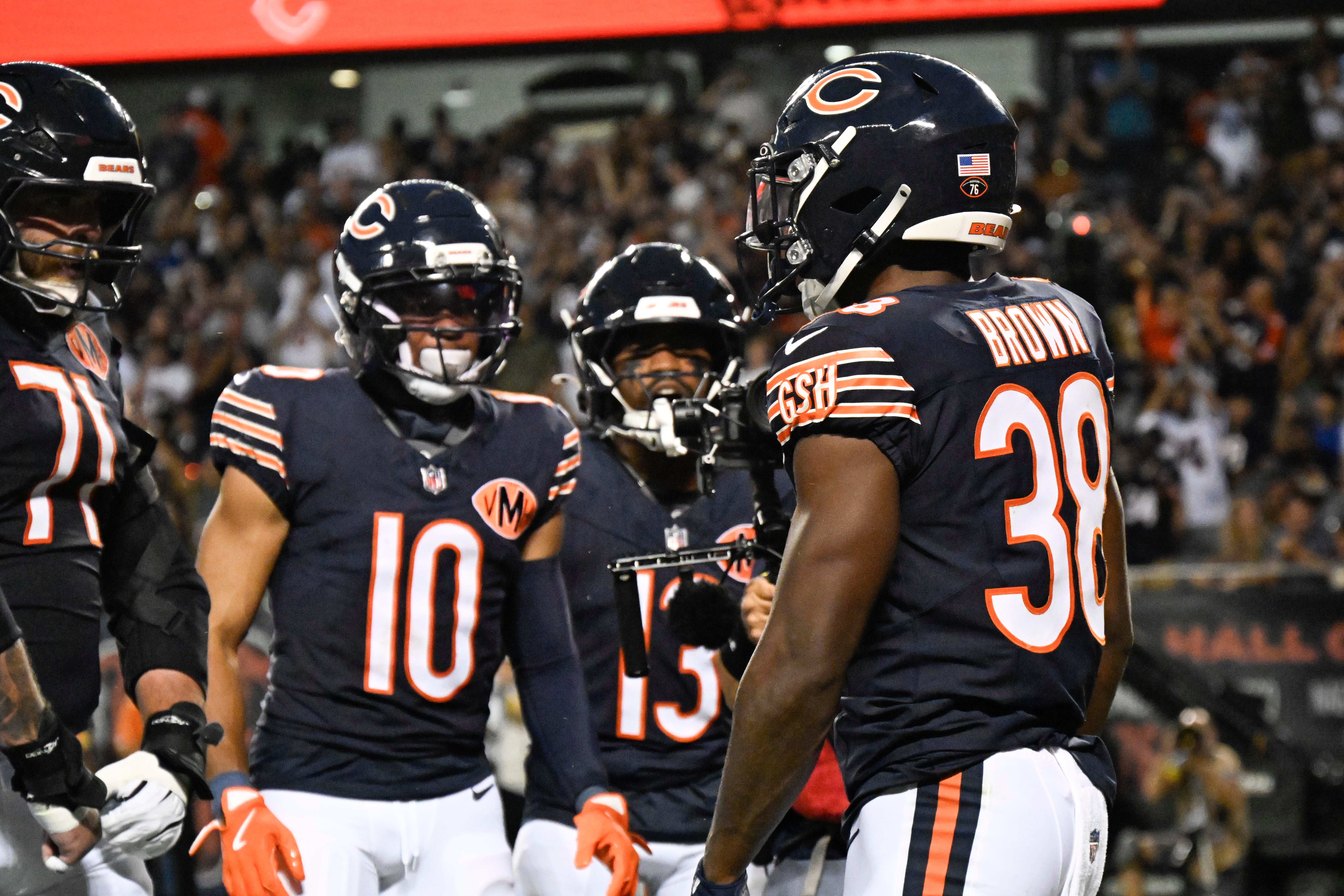Aug 17, 2025; Chicago, Illinois, USA; Chicago Bears running back Brittain Brown (38) celebrates his touchdown with teammates during the first half against the Buffalo Bills at Soldier Field.