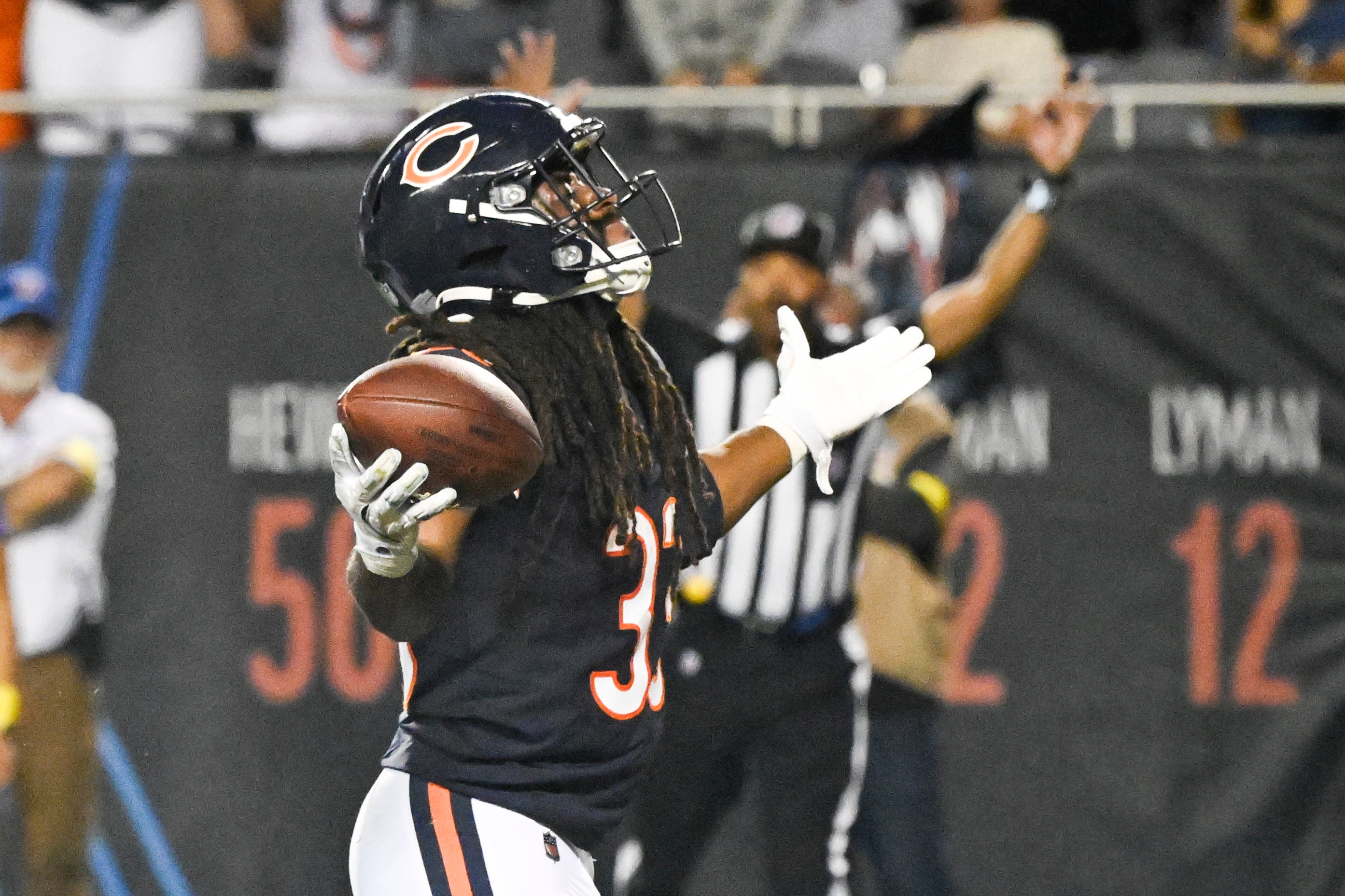Aug 17, 2025; Chicago, Illinois, USA; Chicago Bears running back Ian Wheeler (33) raises his arms after scoring a touchdown during the second half against the Buffalo Bills at Soldier Field.
