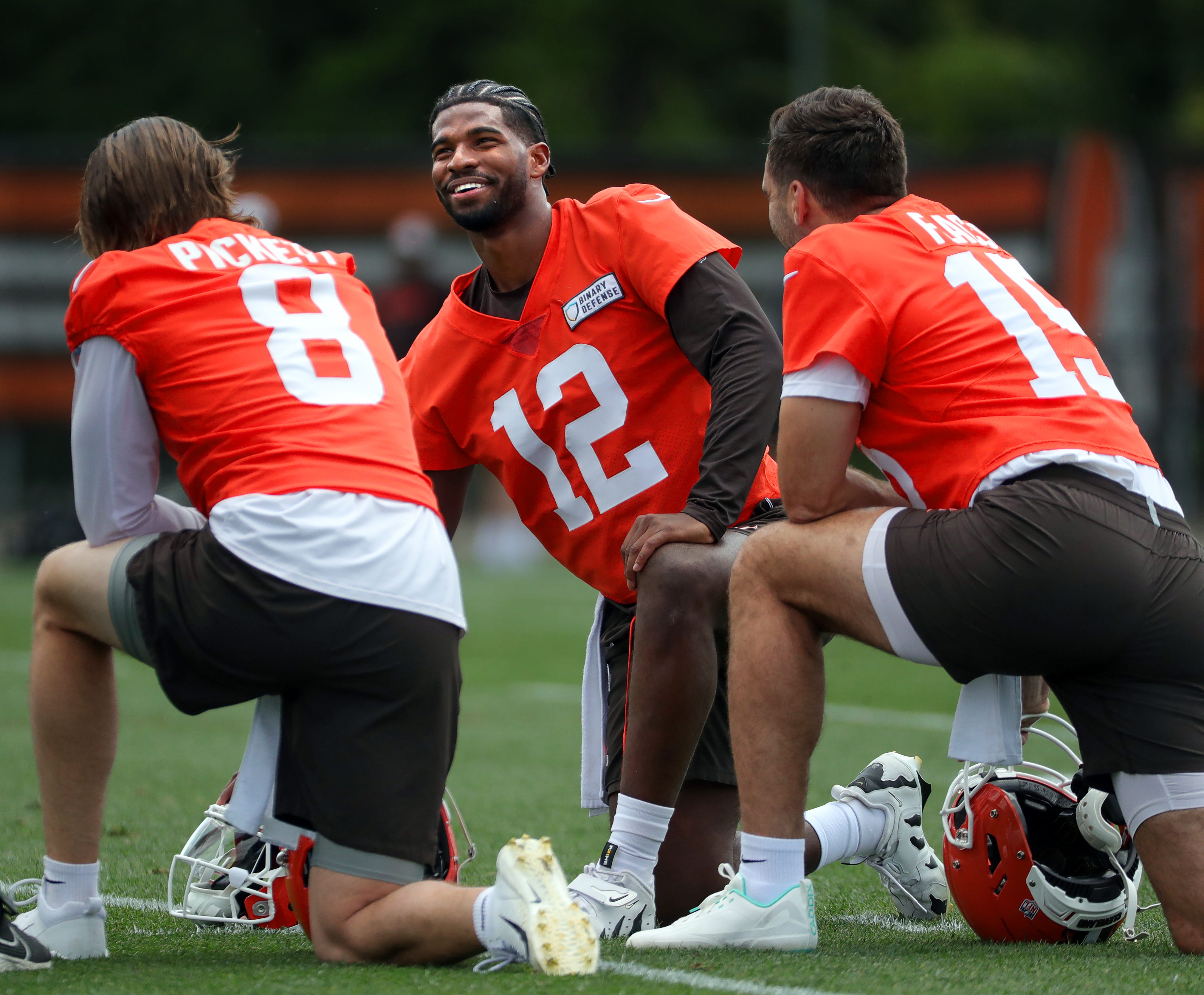 Browns quarterbacks Shedeur Sanders (12), Kenny Pickett (8) and Joe Flacco (15) talk during minicamp June 10, 2025, in Berea.