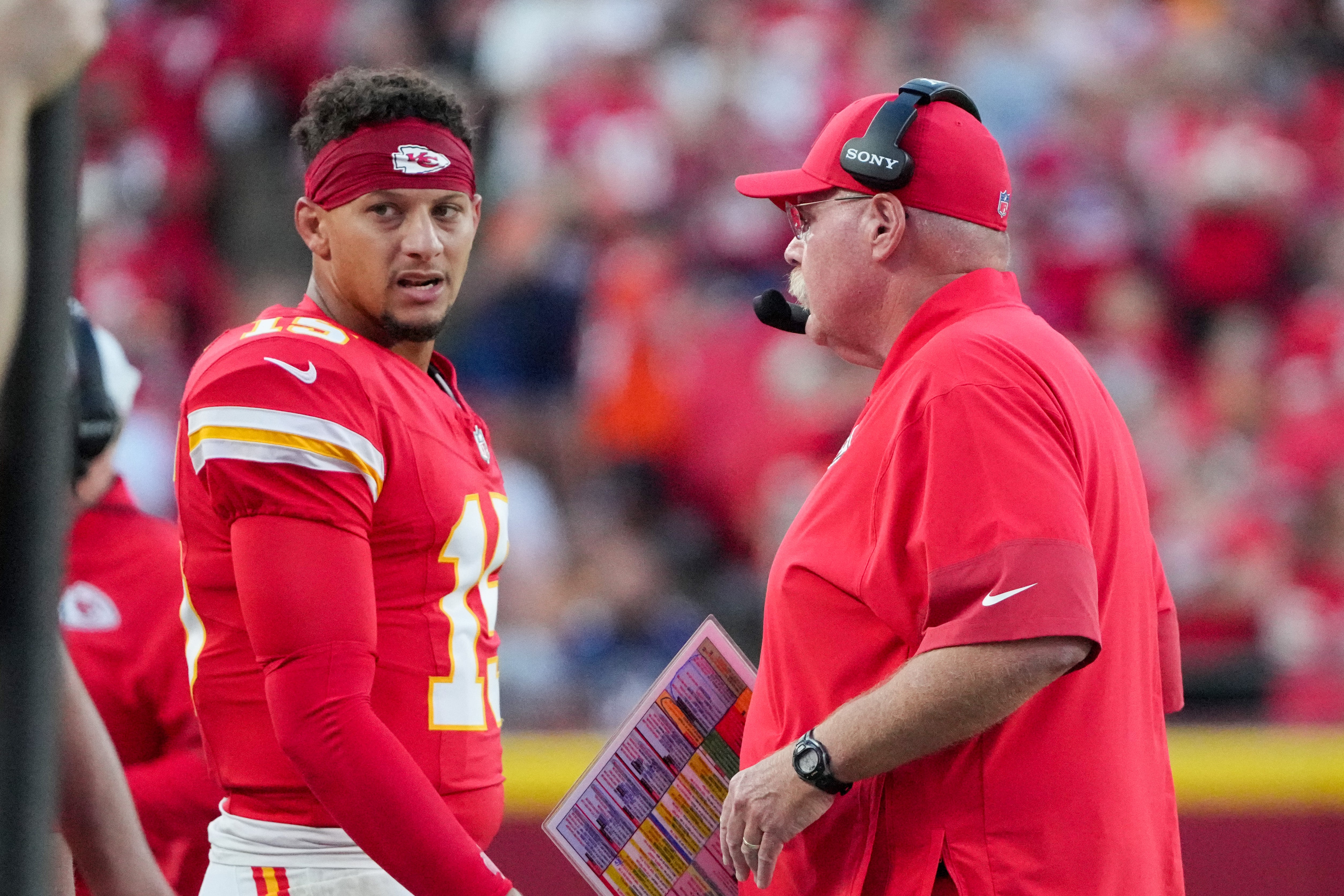 Kansas City Chiefs quarterback Patrick Mahomes (15) talks with head coach Andy Reid after a play against the Chicago Bears during the first half of the game at GEHA Field at Arrowhead Stadium.